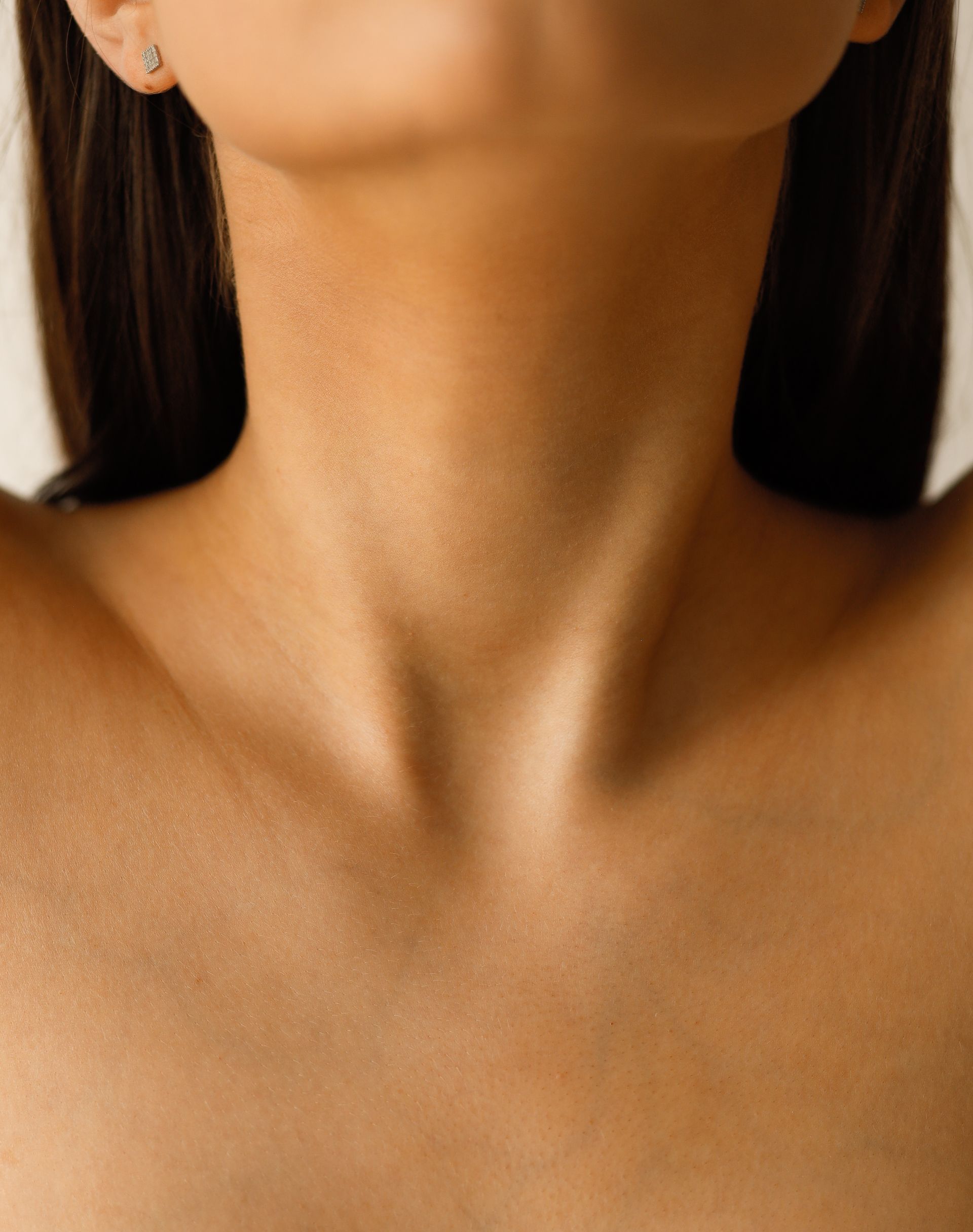 a close up of a woman 's neck and chest