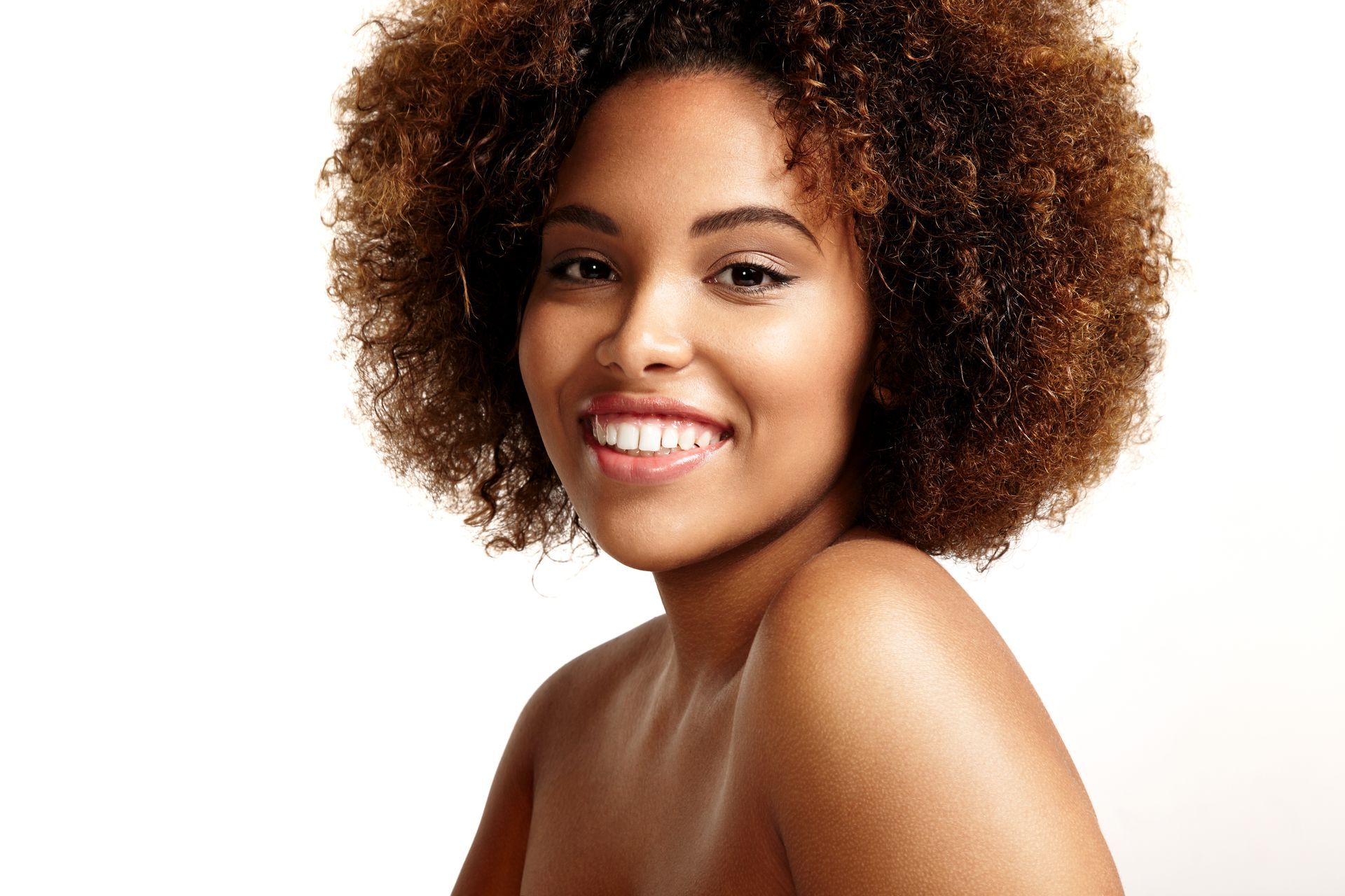 a woman with curly hair smiling