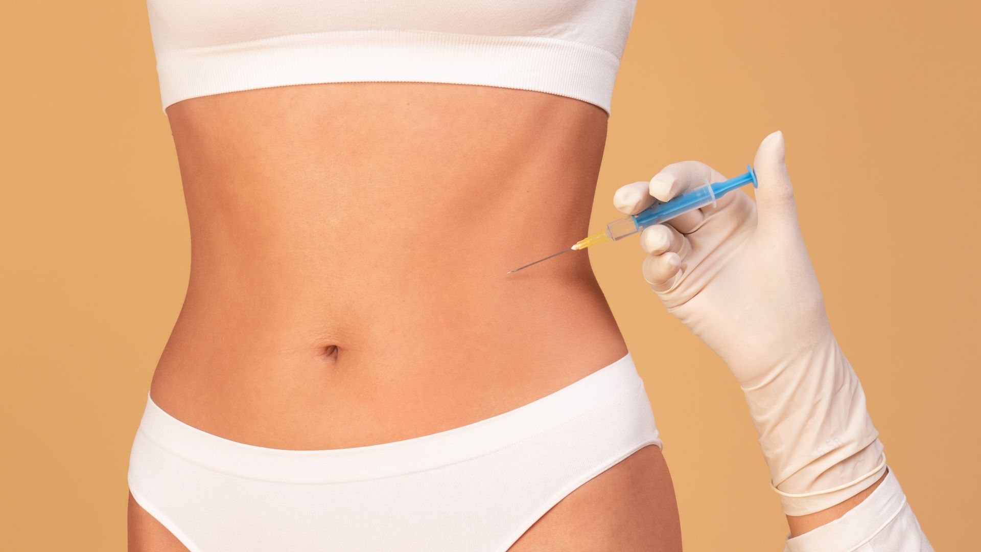 a woman is getting an injection in her stomach