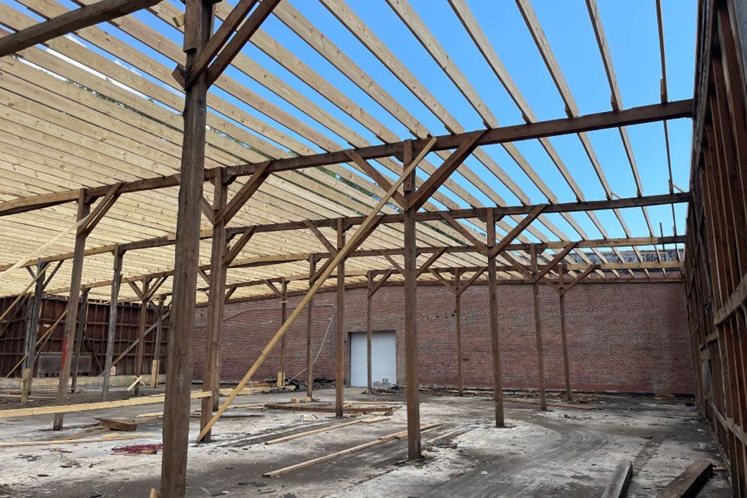The inside of a building under construction with wooden beams.