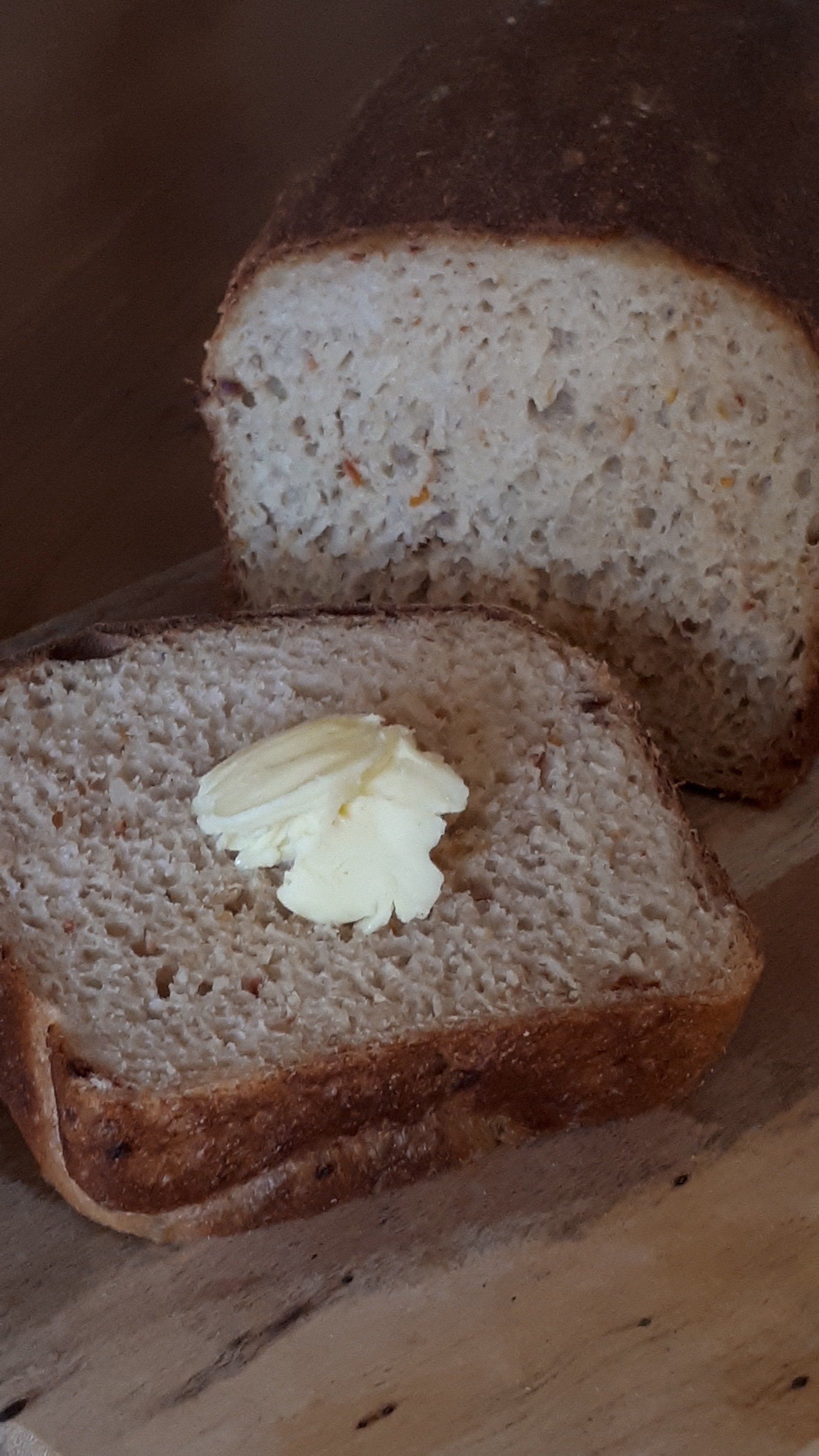 soft wholemeal loaf with knob of buttter on slice