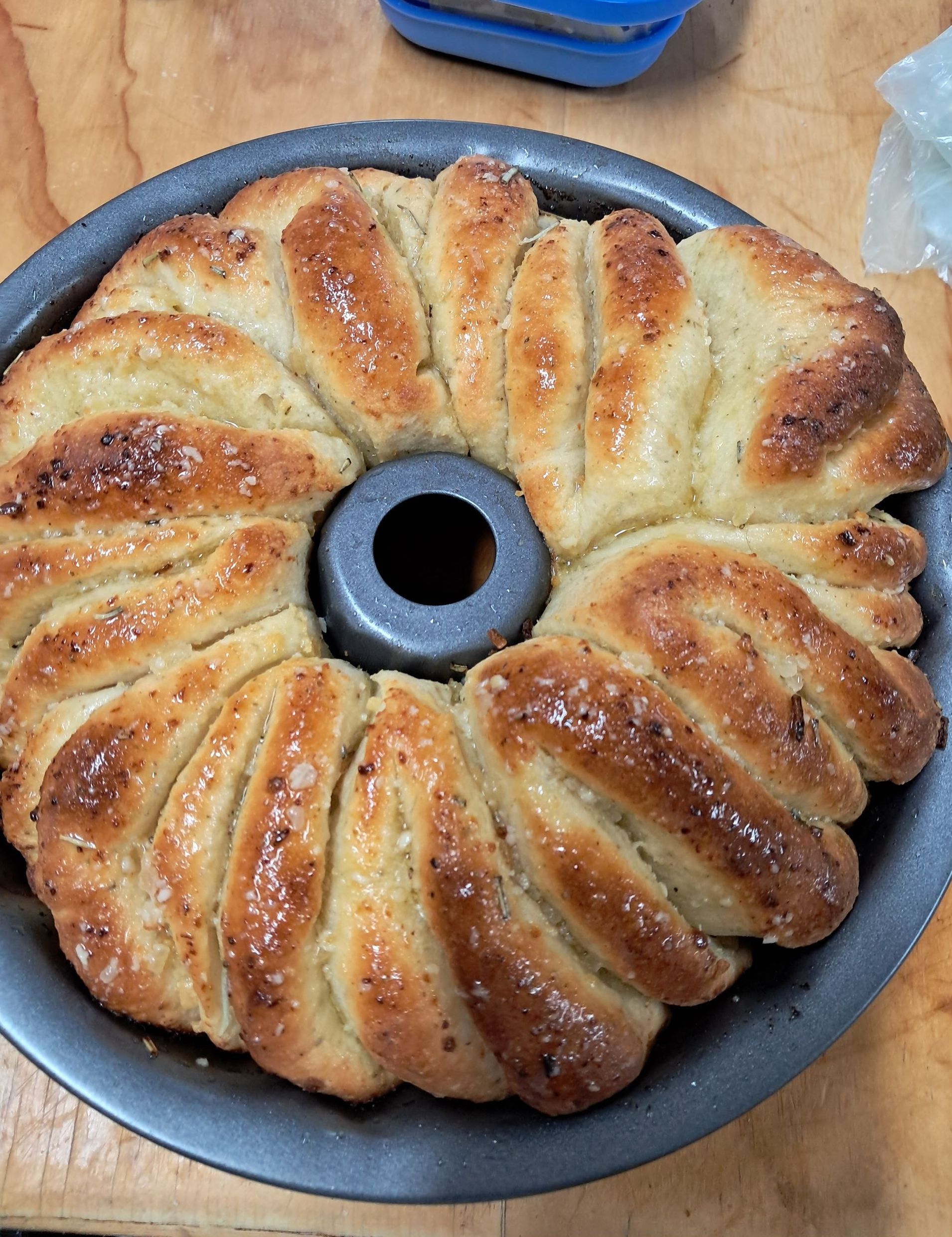 Soft and Fluffy garlic and herb bread festive wreath on blue round plate