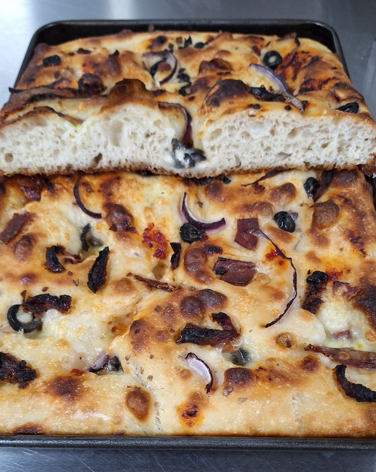 sliced white focaccia with onion cheese and tomato