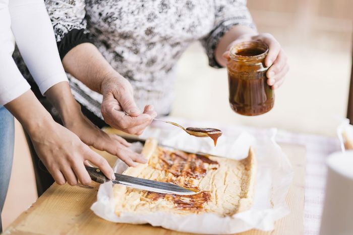 demonstrating how to apply sauce