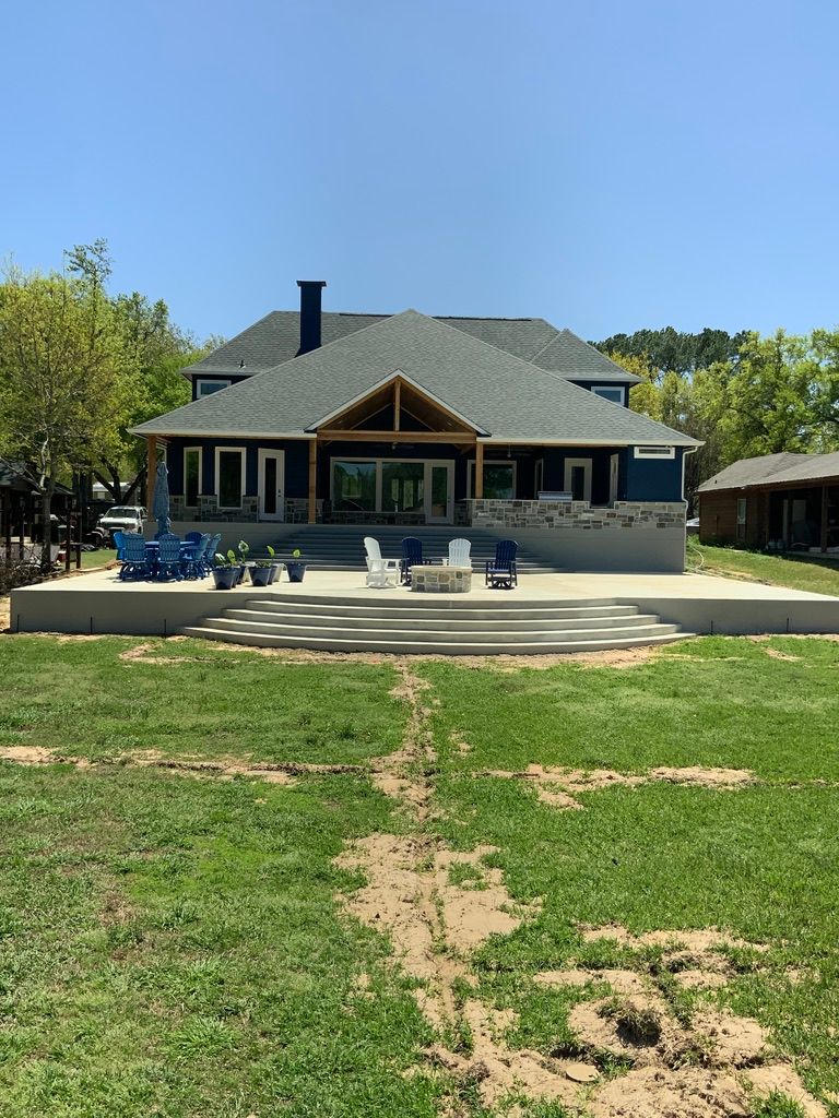 A large house with a large lawn in front of it.