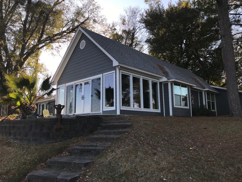 A house with a lot of windows and stairs leading up to it