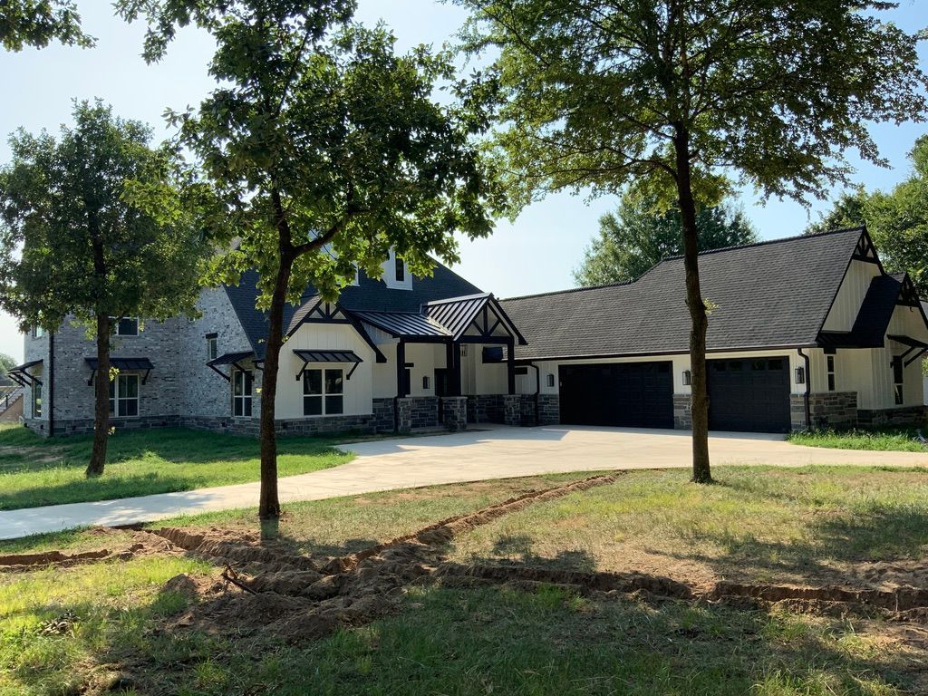 A large house with a lot of trees in front of it