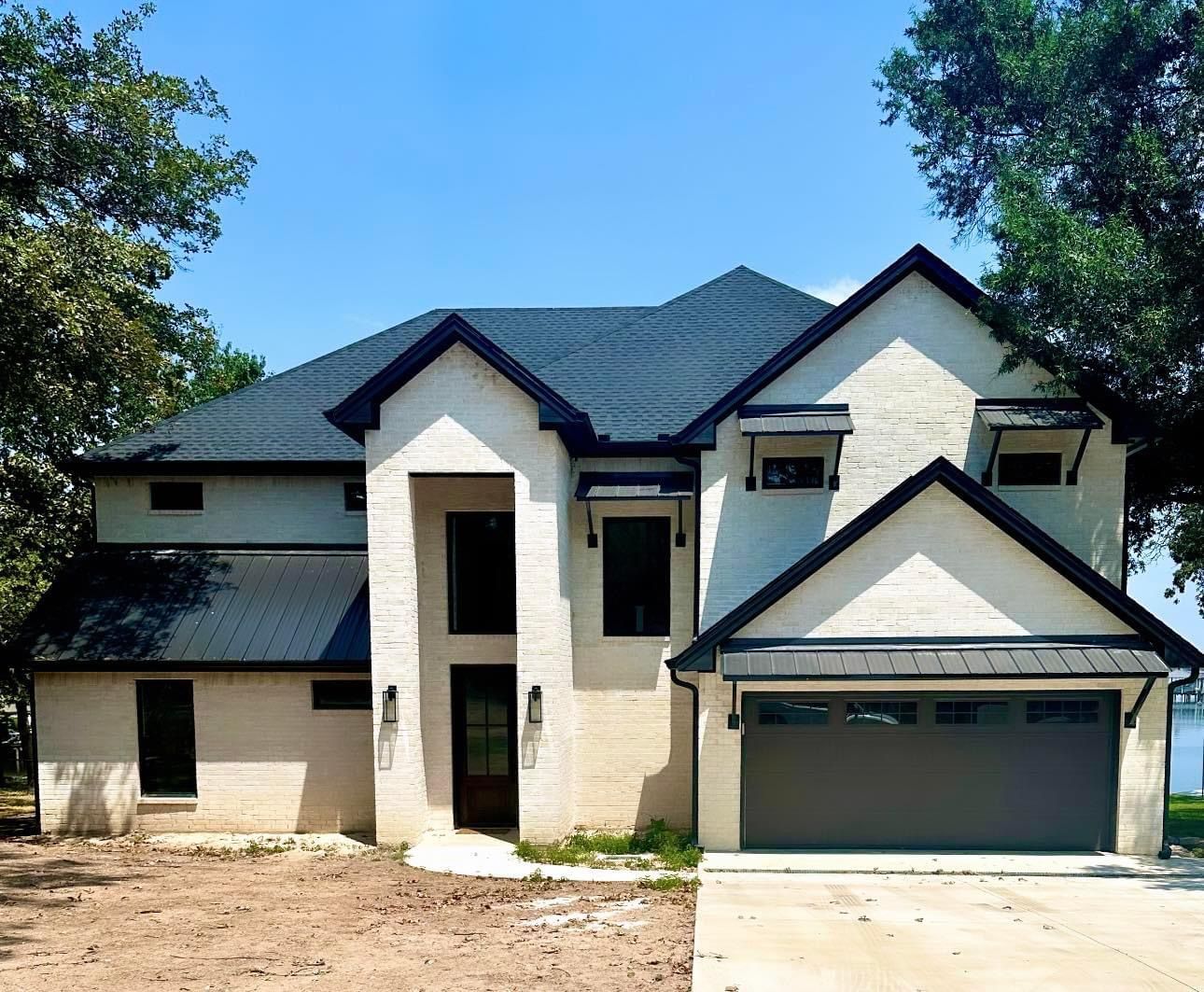 A large white house with a black roof