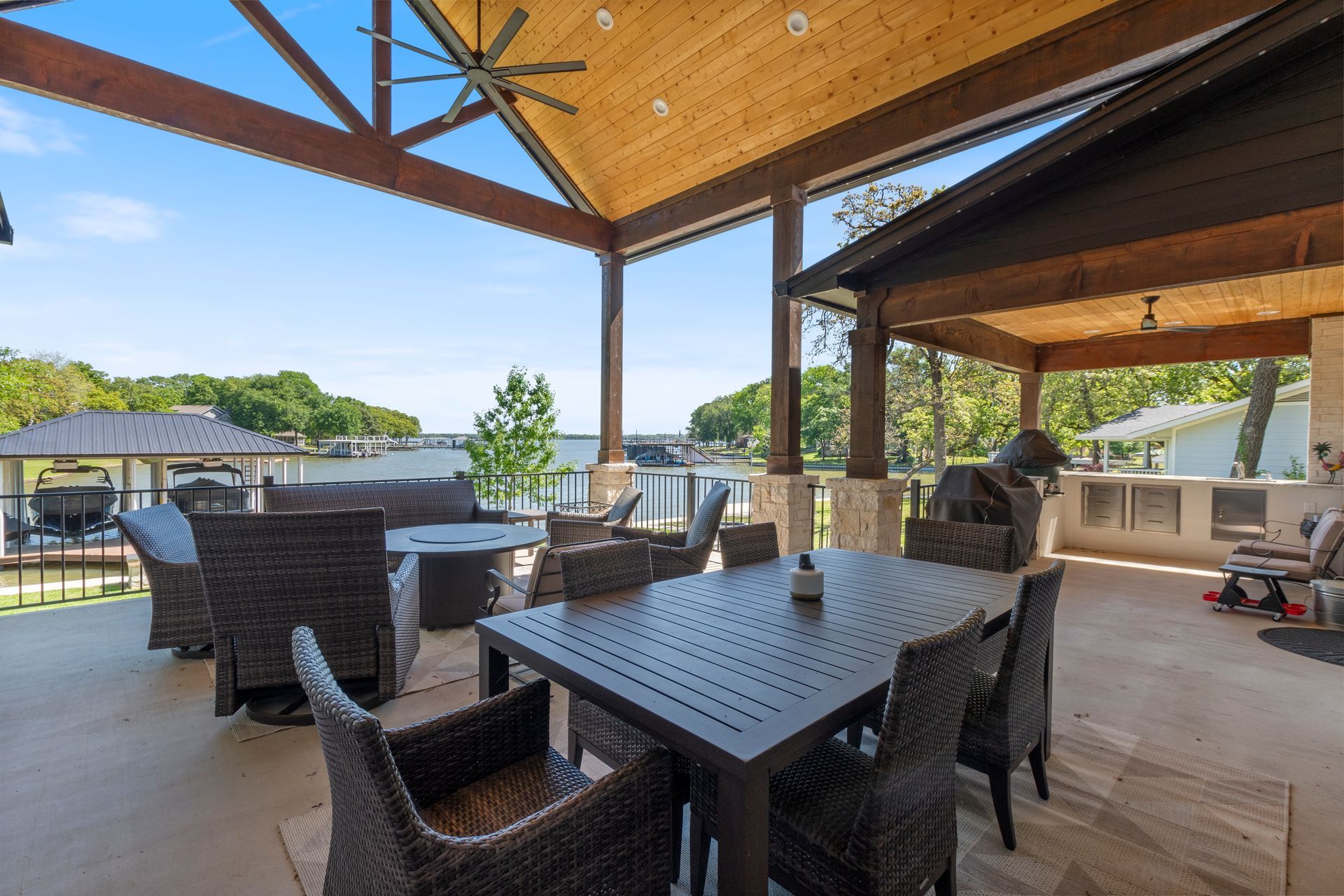 There is a table and chairs on the patio with a view of the water.