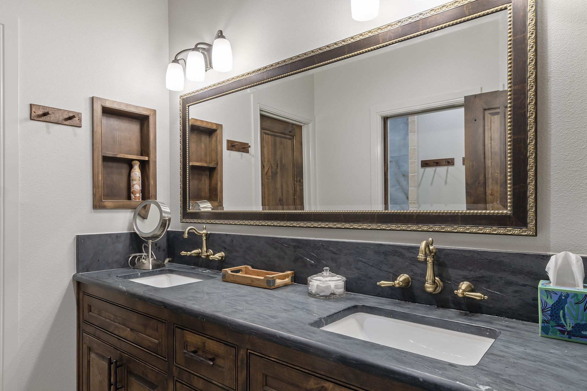 A bathroom with two sinks and a large mirror.