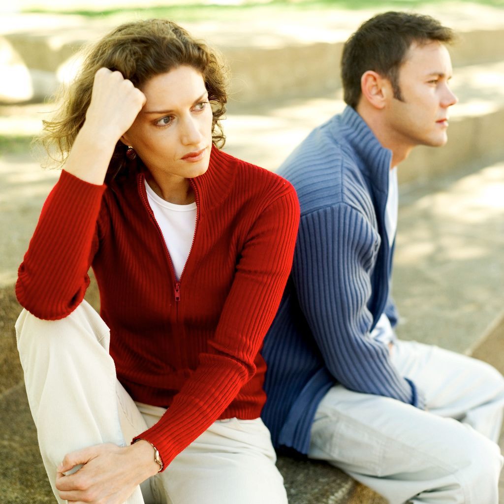 Young Couple Seated Back To Back