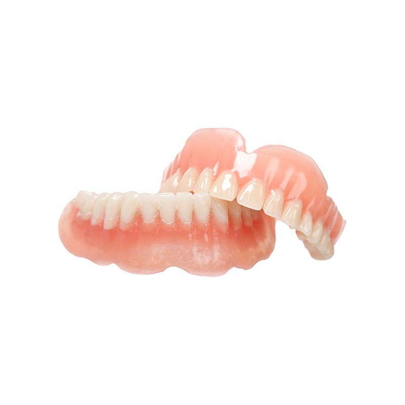 Set of pink and white dentures on a white background