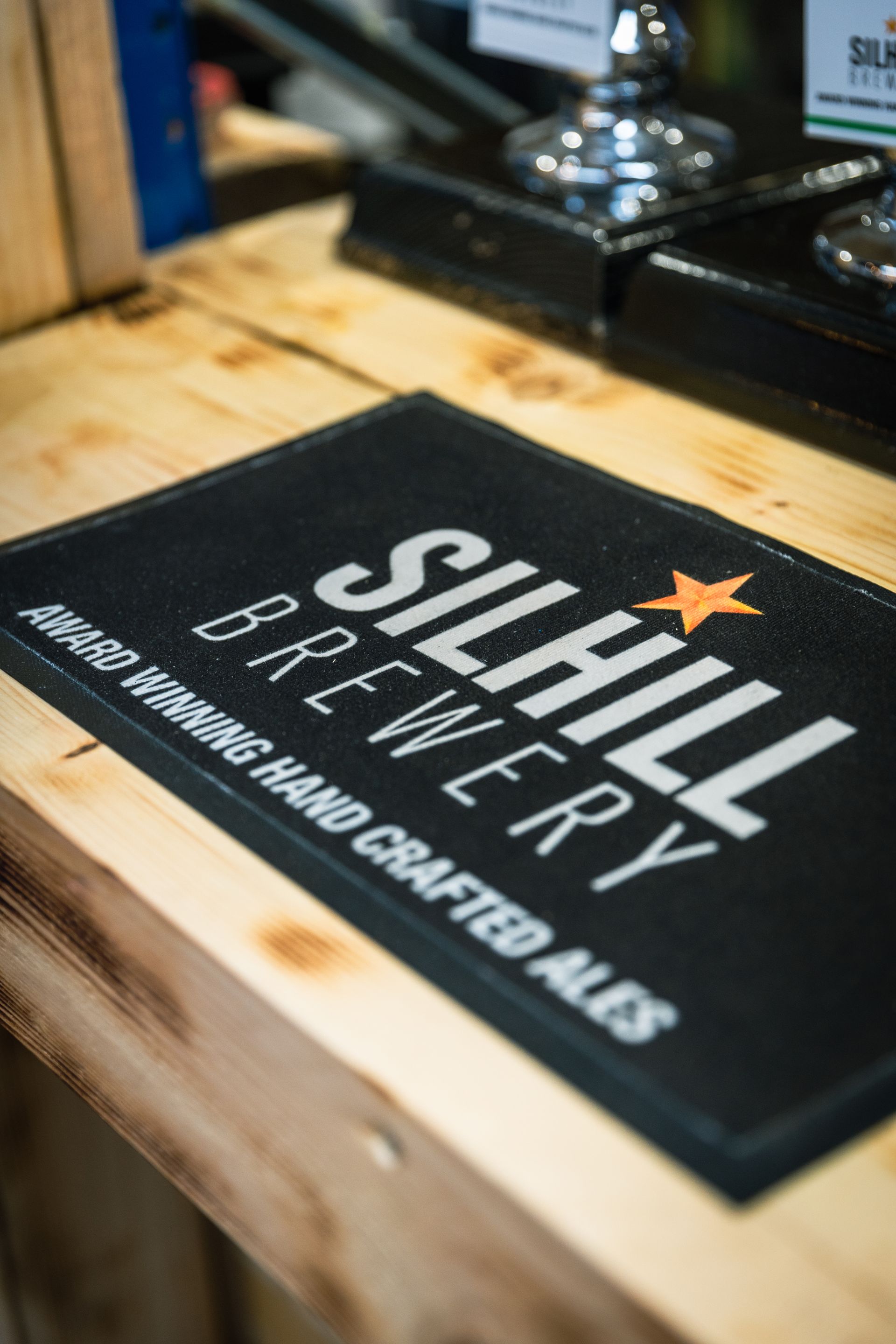 A black mat that says silhill brewery on it