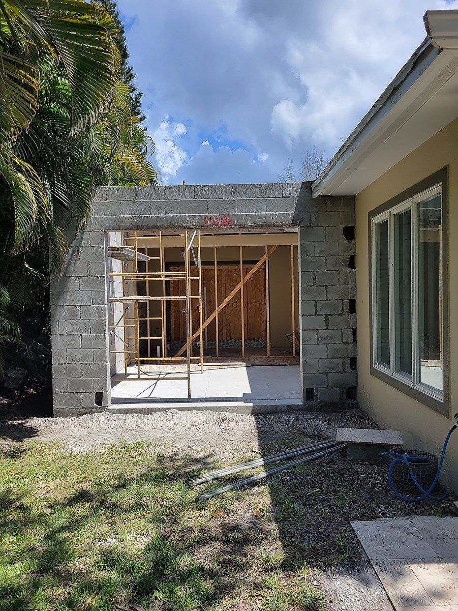 A house is being remodeled and a garage door is being built.