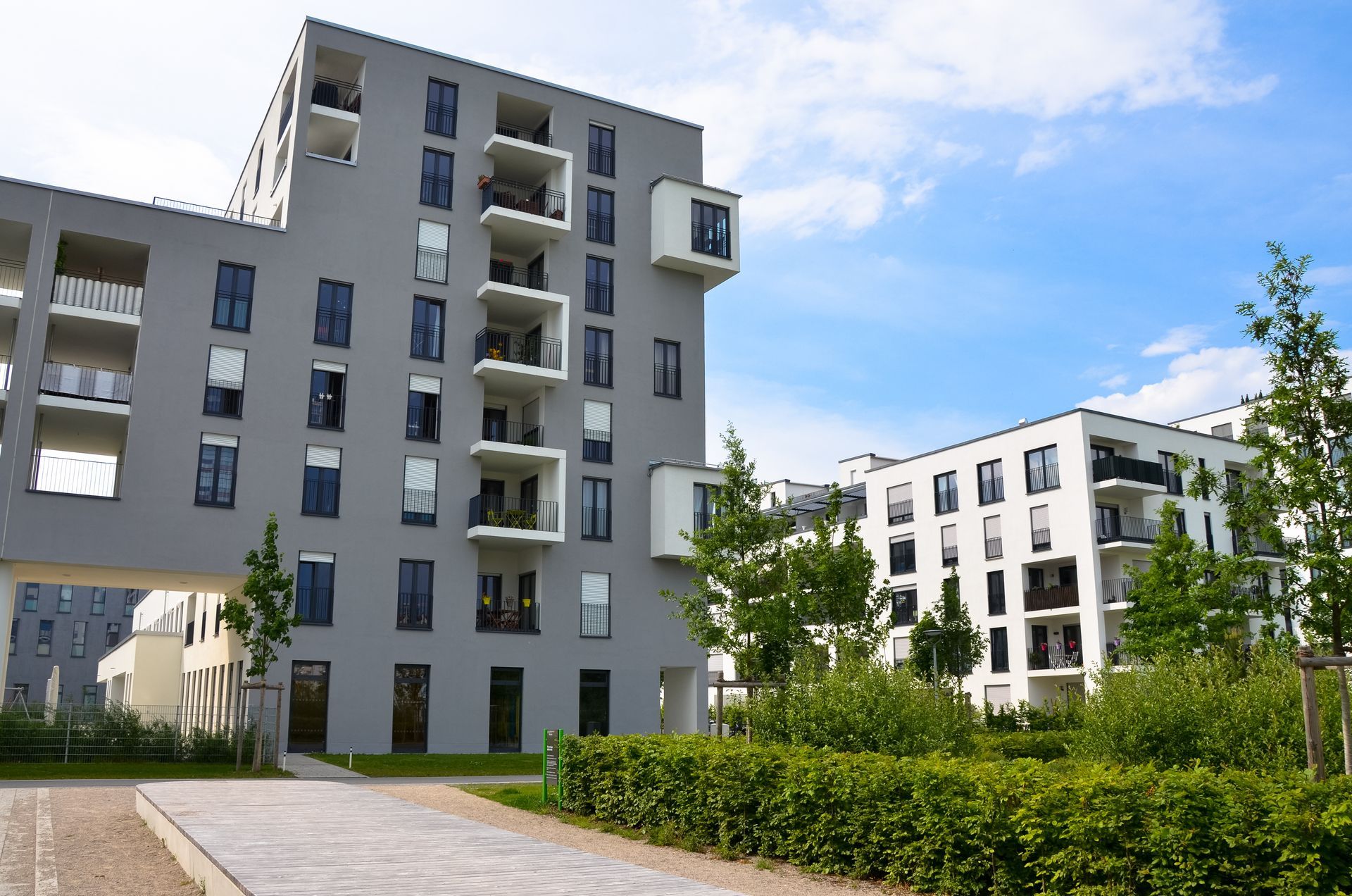 A row of apartment buildings with a blue sky in the background