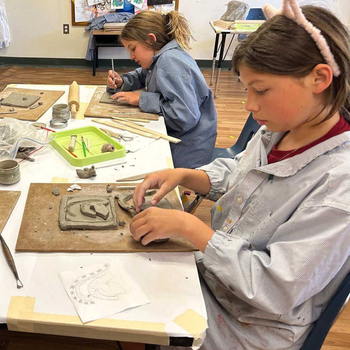 An Upper Elementary student works on her clay sculpture in Art Class.