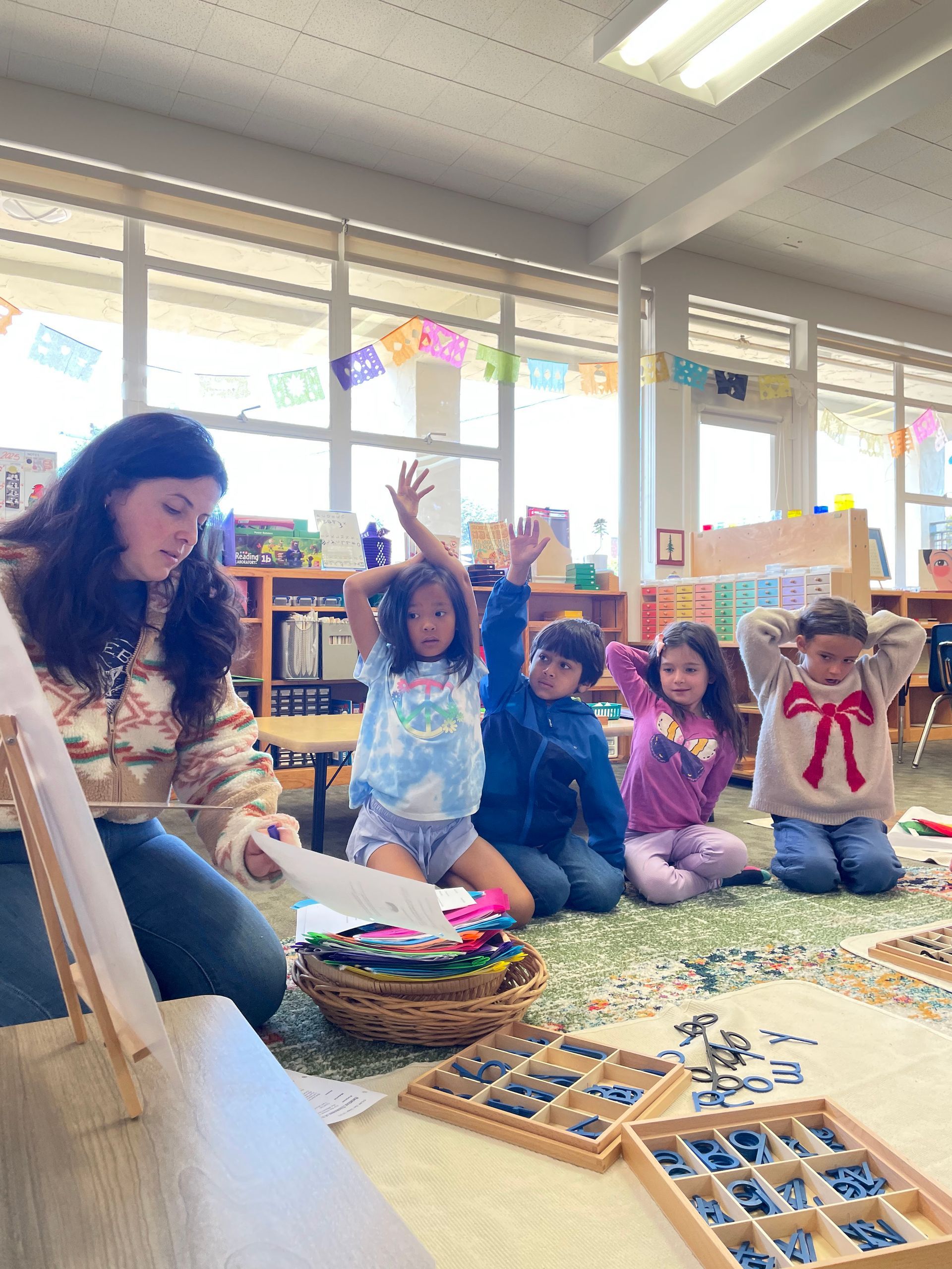 A teacher gives a language lesson to a small group of students.