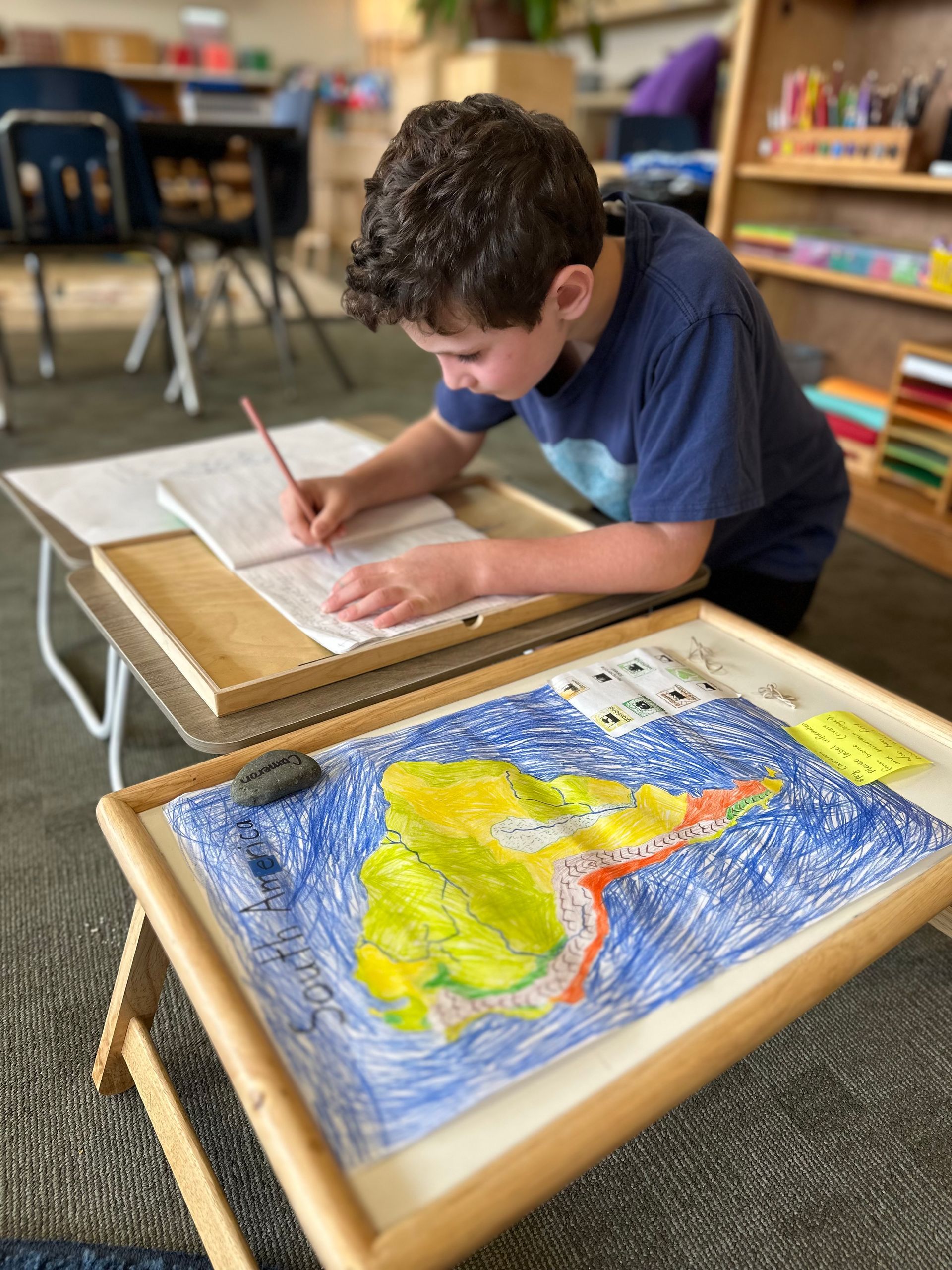 A Lower Elementary student finished up his report on South America. Geography is a big part of the Montessori curriculum.