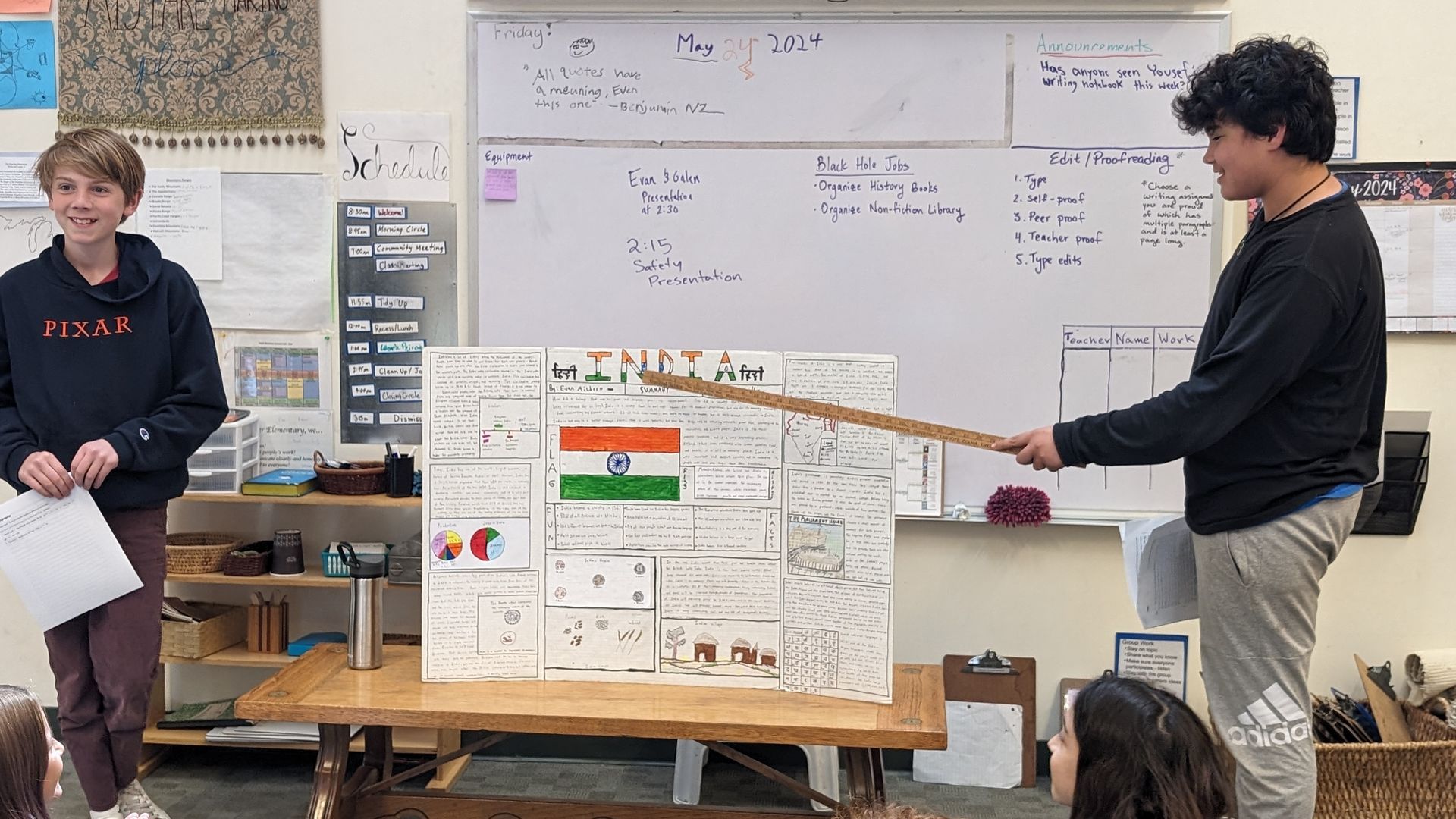 Two Upper Elementary students presenting a research poster about the country of India. This is an example of freedom of choice in the Montessori curriculum.