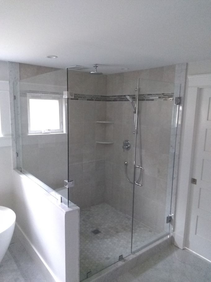 A bathroom with a walk in shower and a toilet.