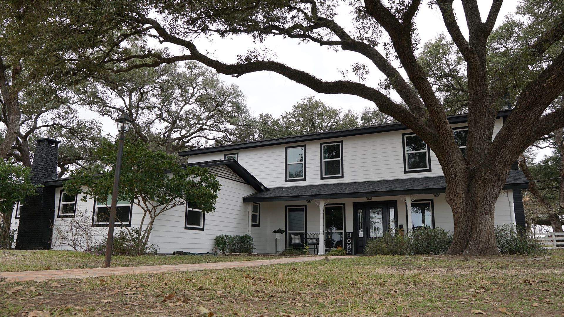 A large white house with trees in front of it