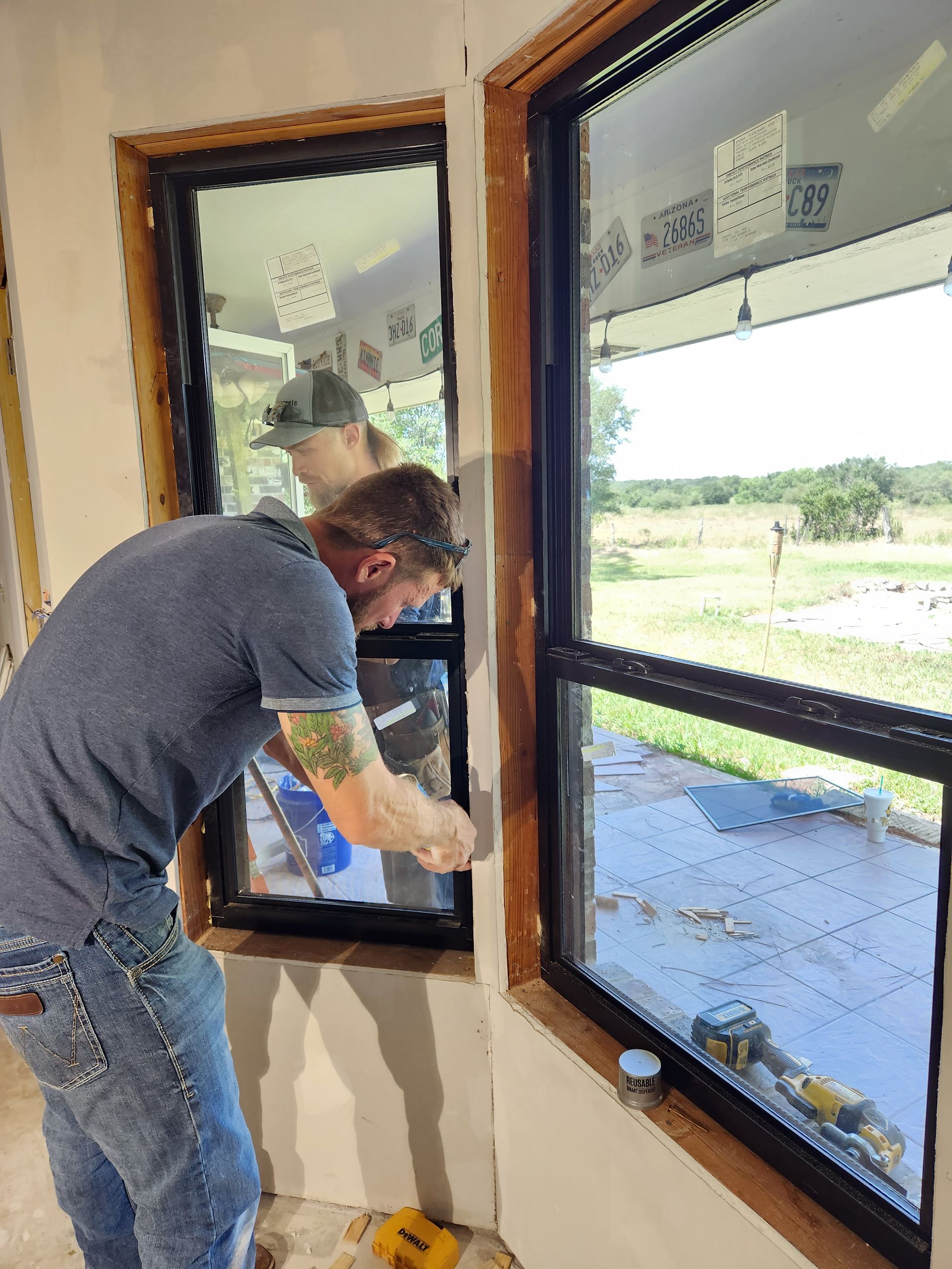 A man is installing a window in a room.