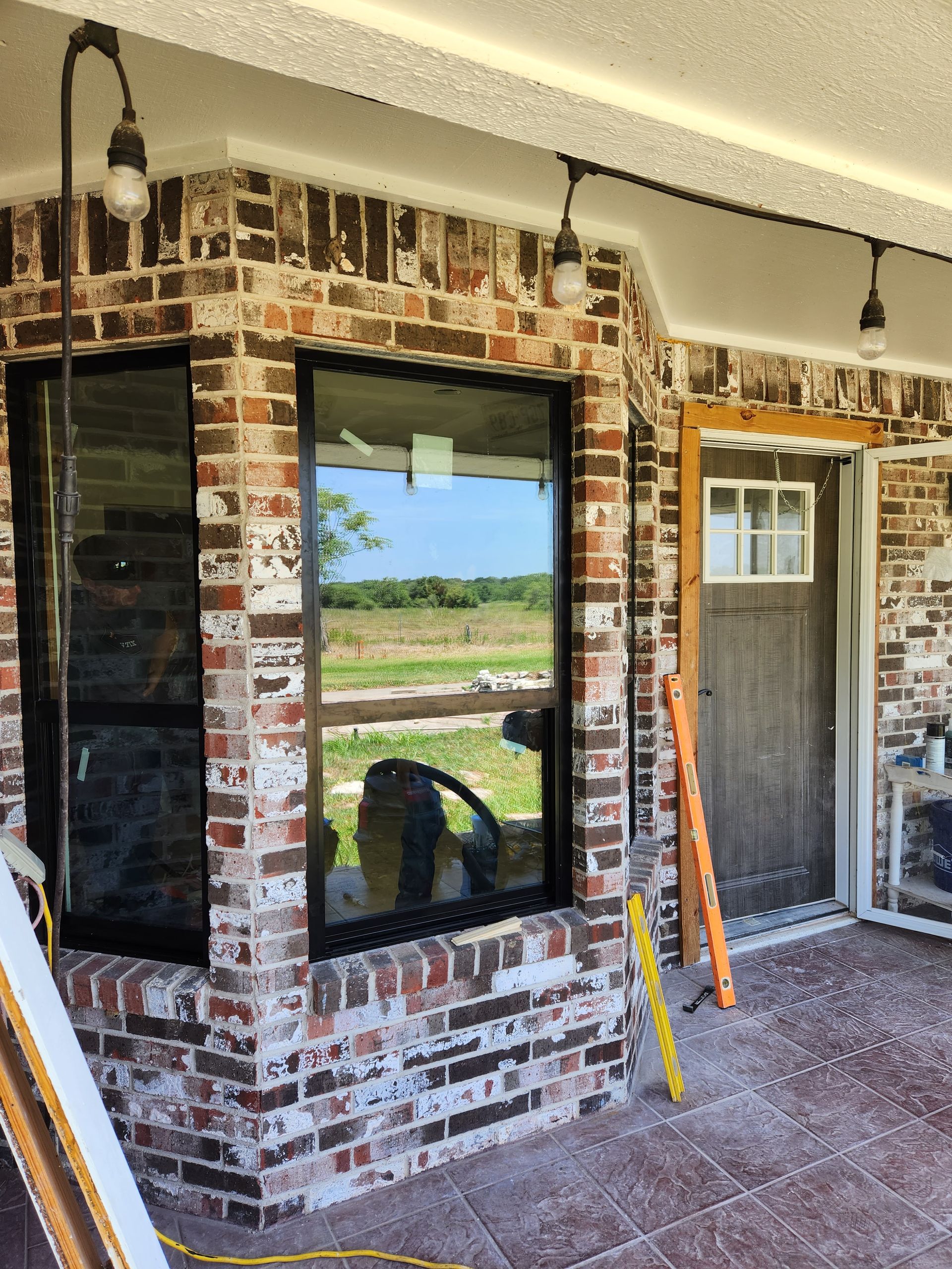 A brick building with two windows and a door