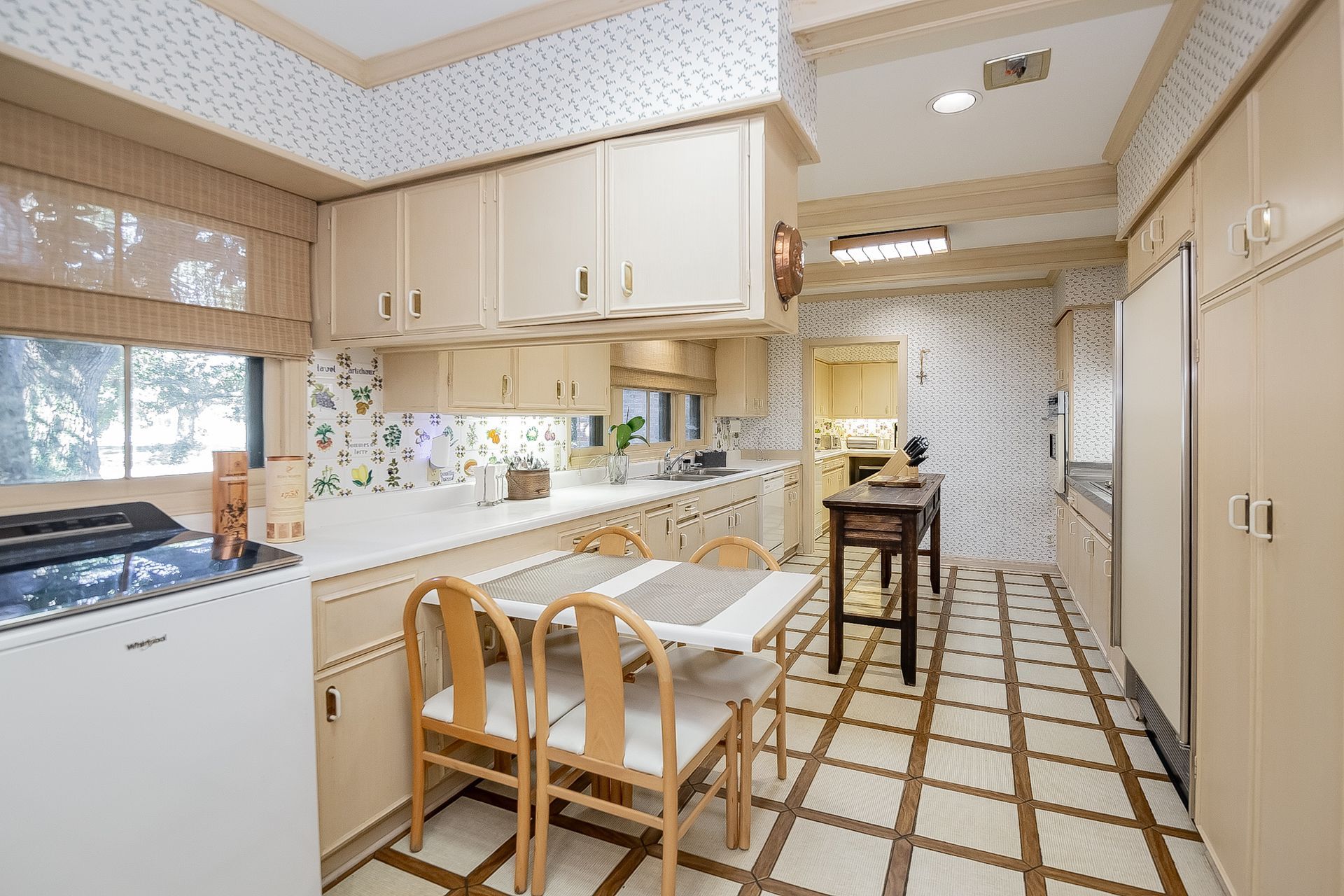 A kitchen with a table and chairs in it