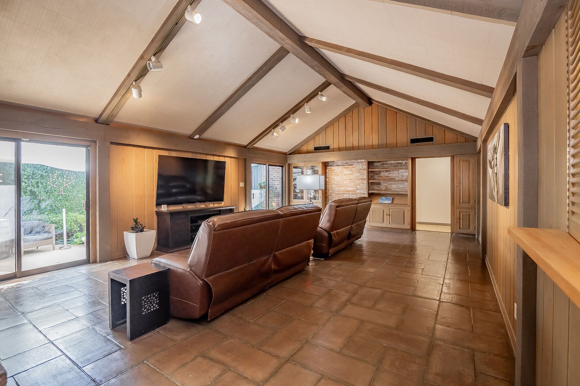 A living room with a couch and a flat screen tv