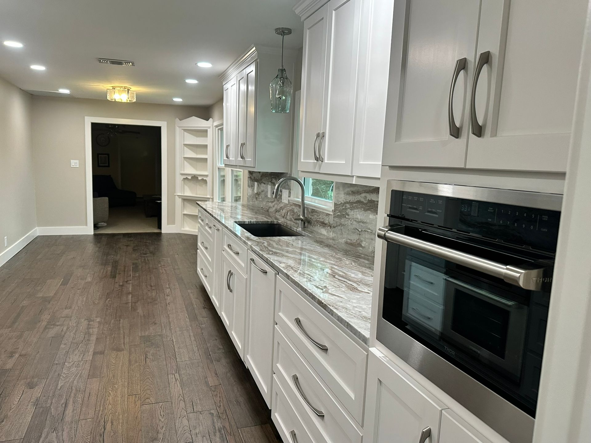 A kitchen with white cabinets and stainless steel appliances