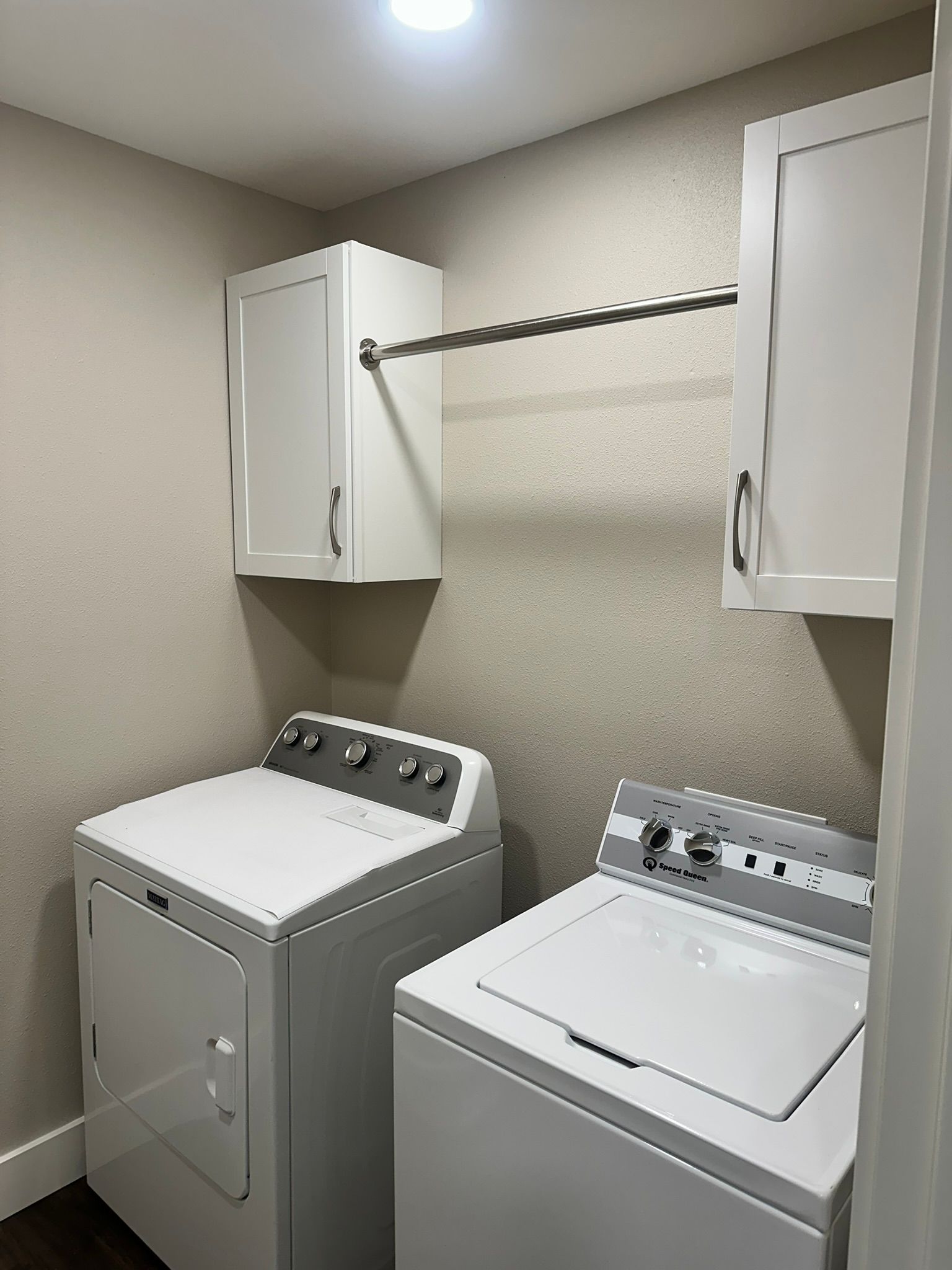 A laundry room with a washer and dryer in it