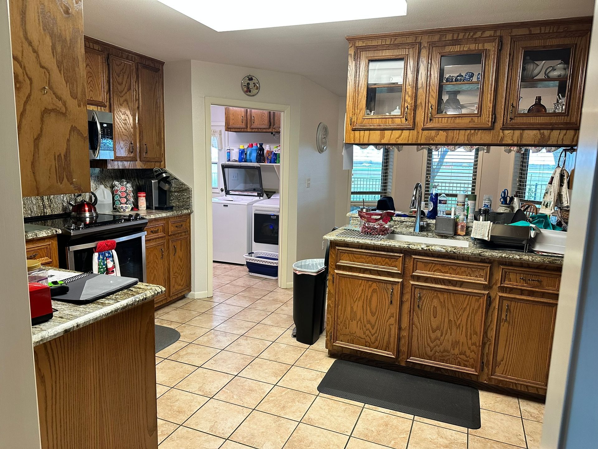 A kitchen with wooden cabinets and granite counter tops