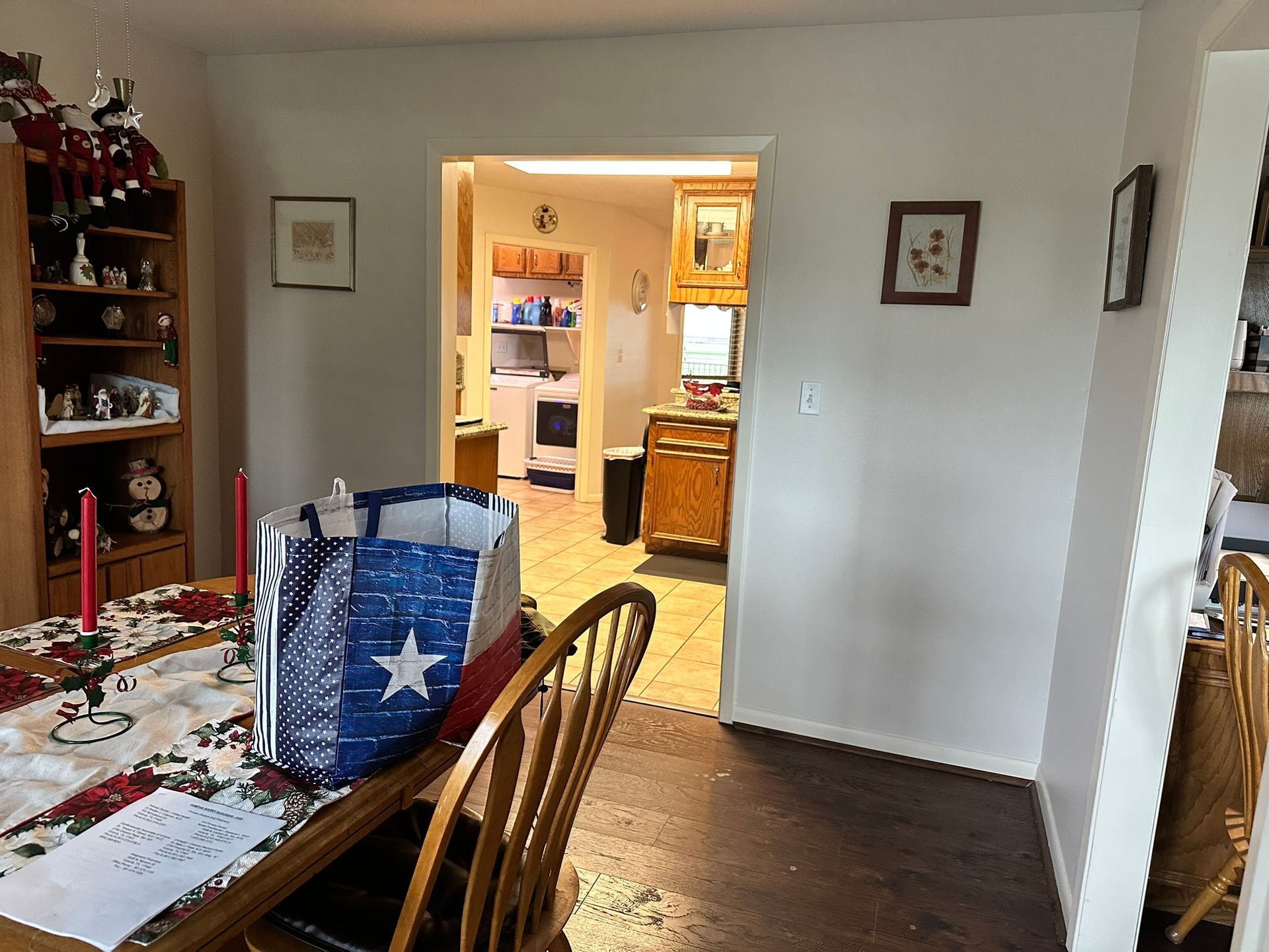 A dining room with a table and chairs and a blue bag with a star on it
