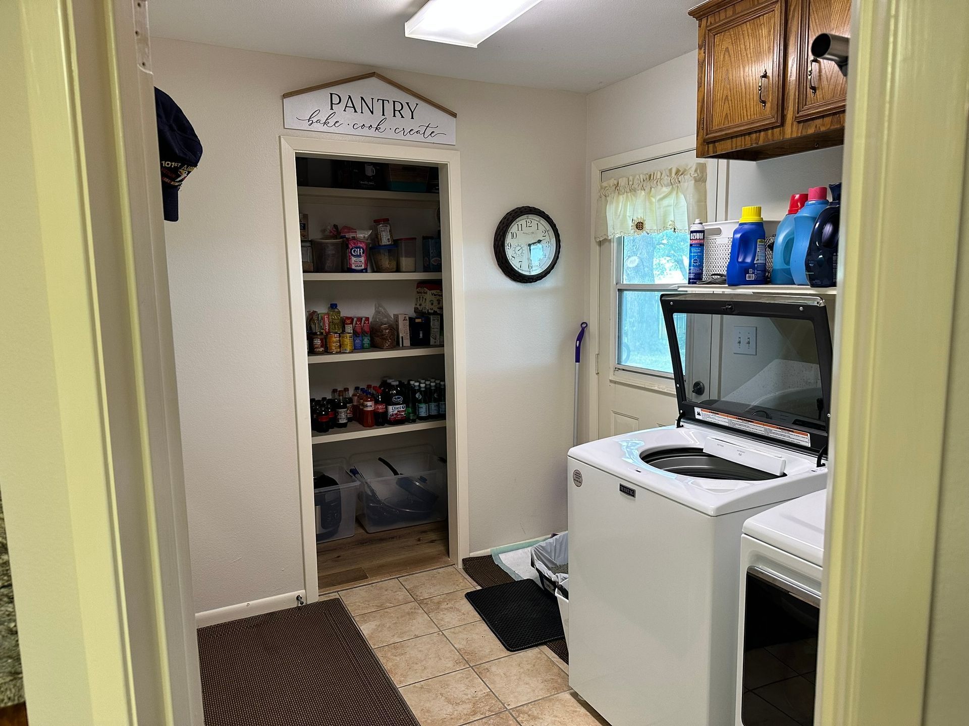 A laundry room with a washer and dryer and a pantry.