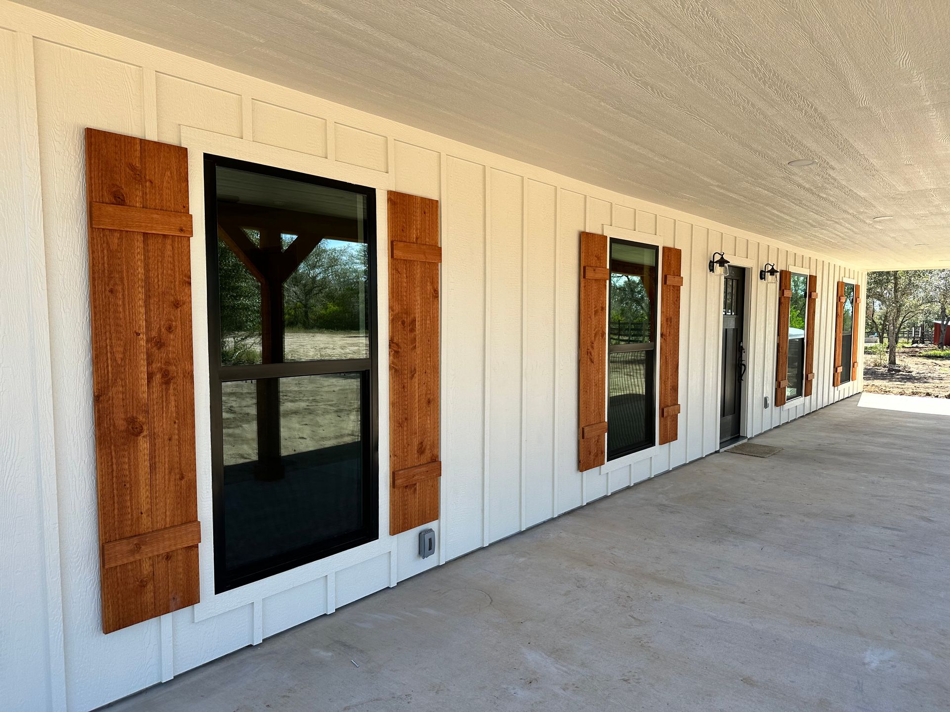 A white house with wooden shutters on the windows