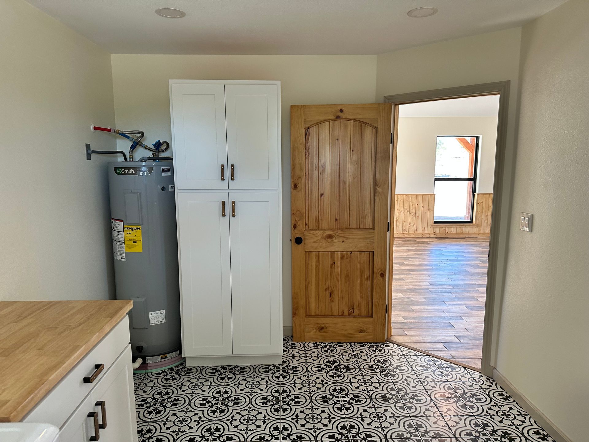 There is a water heater in the middle of the room.