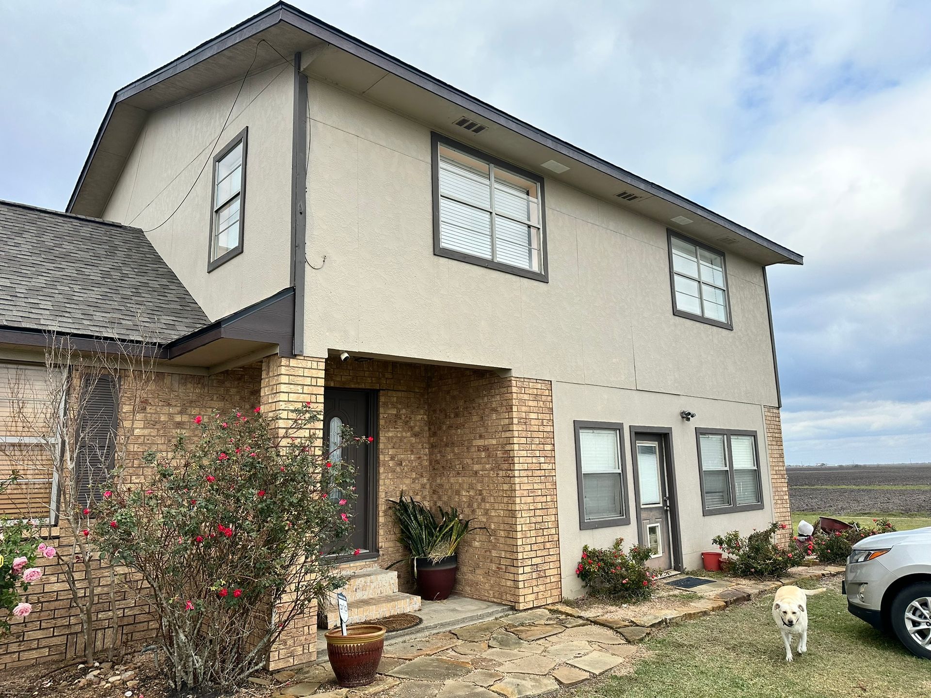 A house with a car parked in front of it