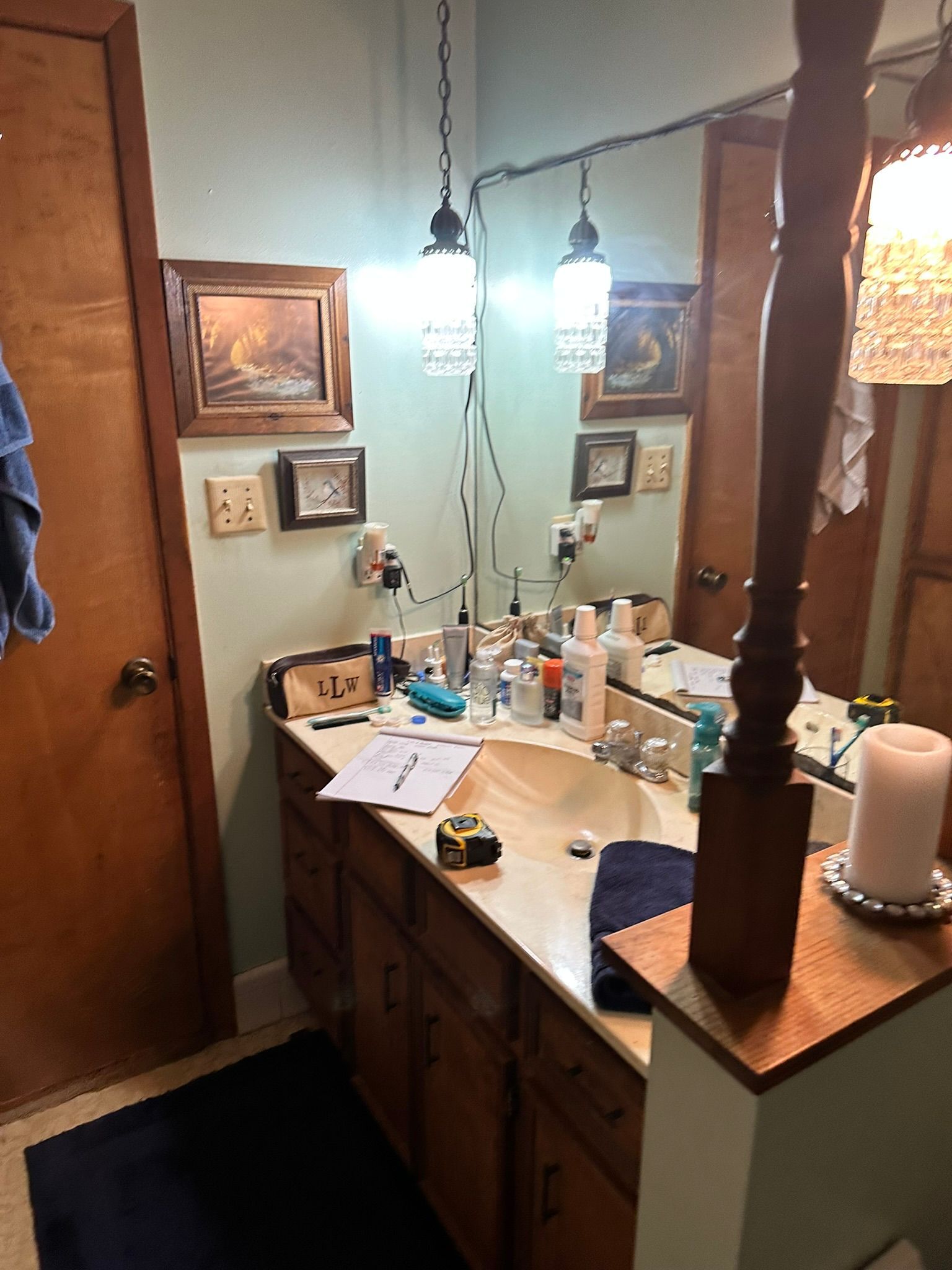A bathroom with a sink , mirror and candles