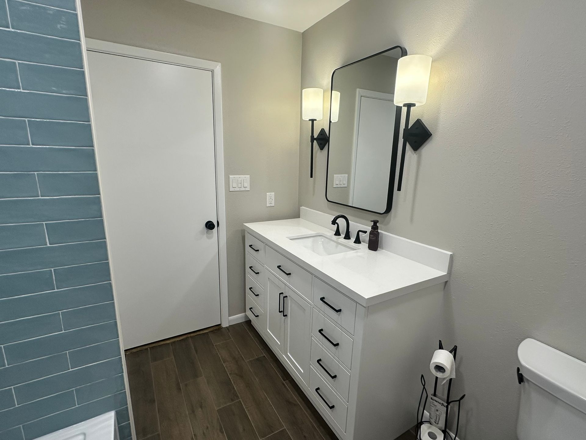 A bathroom with two sinks , a toilet , and a mirror.