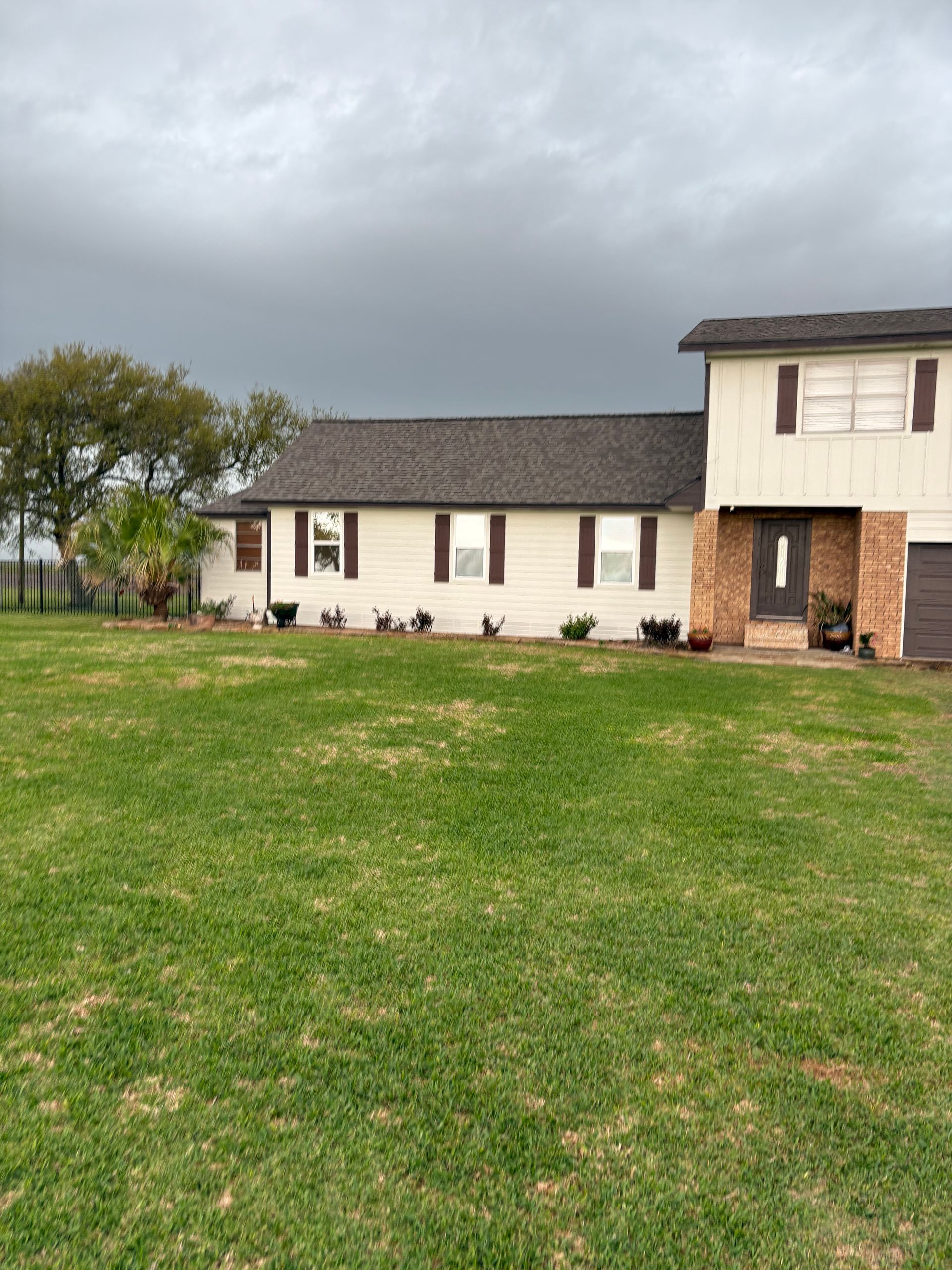 A house with a large lawn in front of it