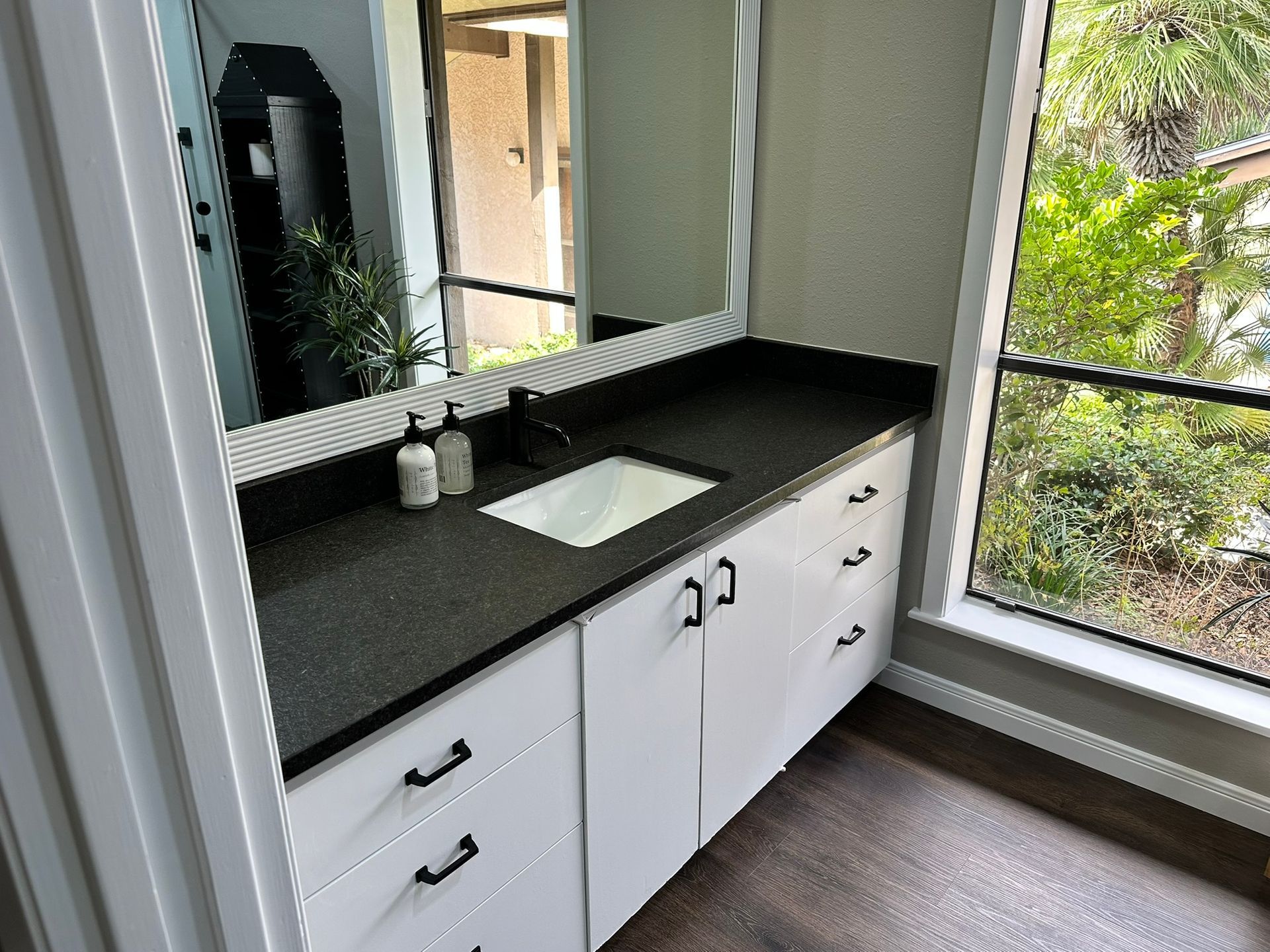 A bathroom with a sink and a large mirror