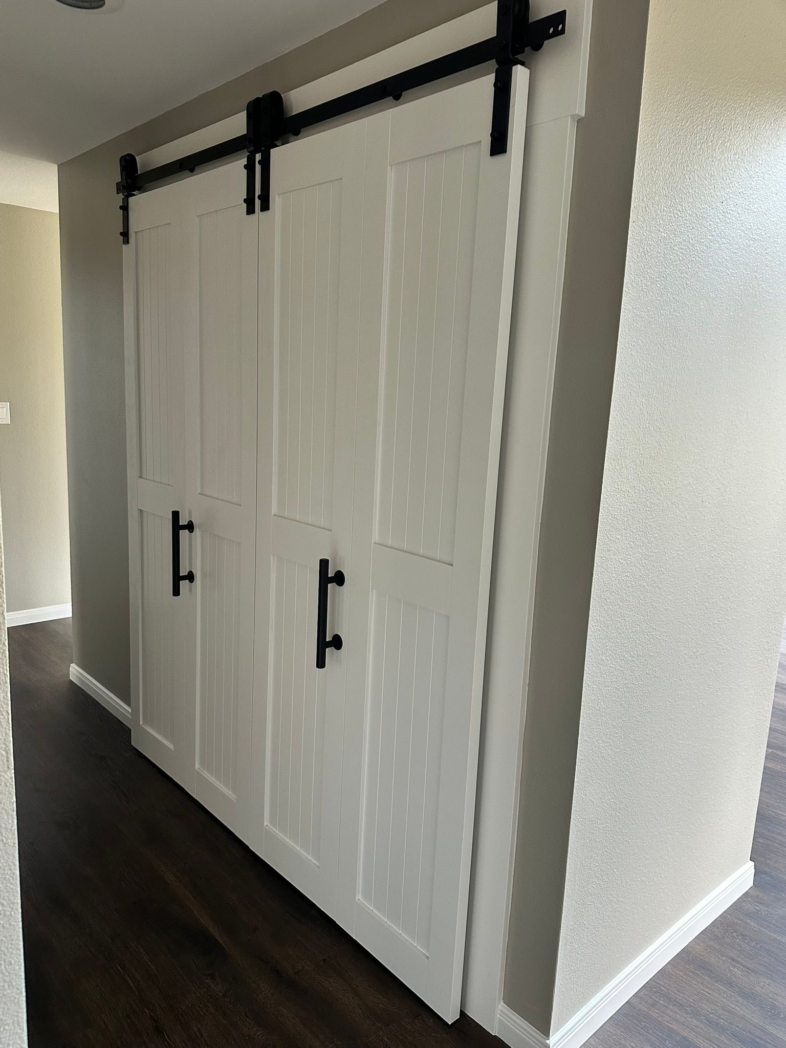 A closet with sliding barn doors in a house.