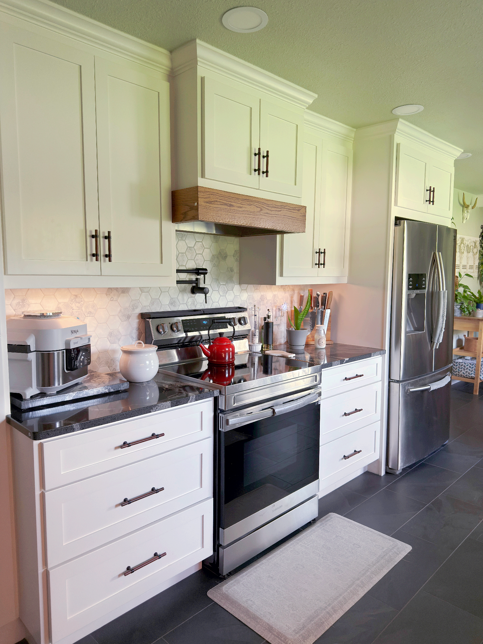 A kitchen with white cabinets and stainless steel appliances