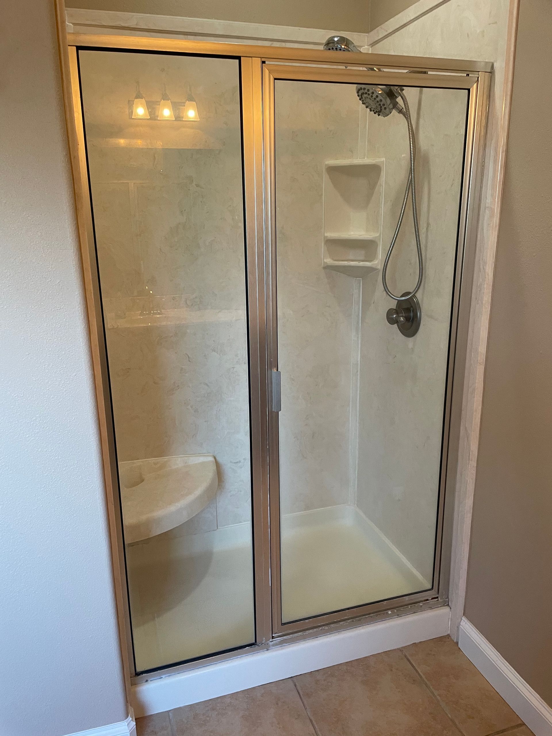 A bathroom with a walk in shower and a toilet