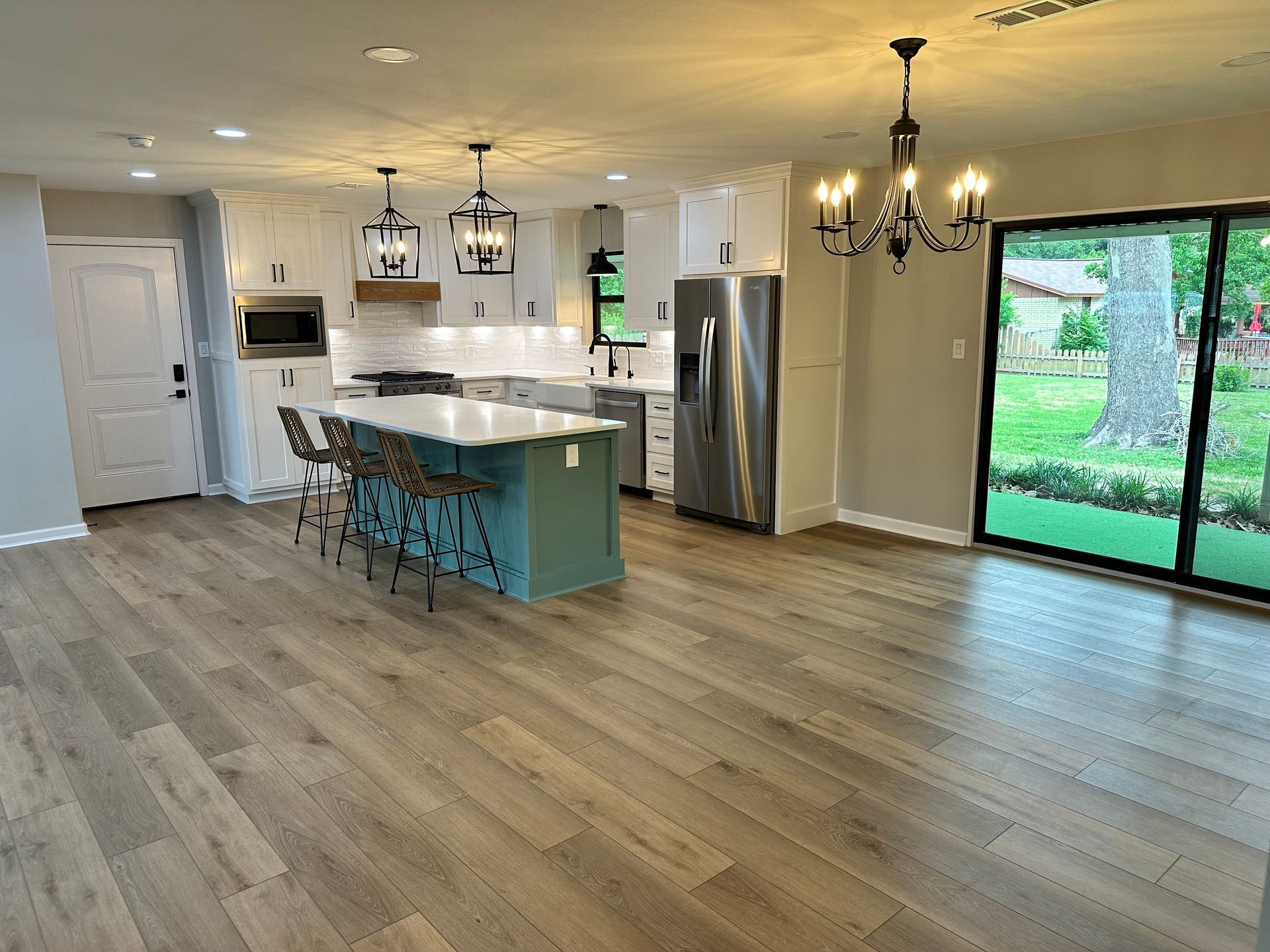 A kitchen with a large island and stainless steel appliances.