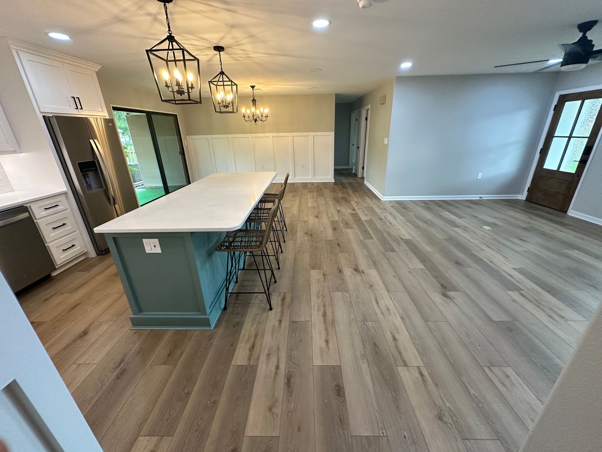 A kitchen with hardwood floors and a large island.