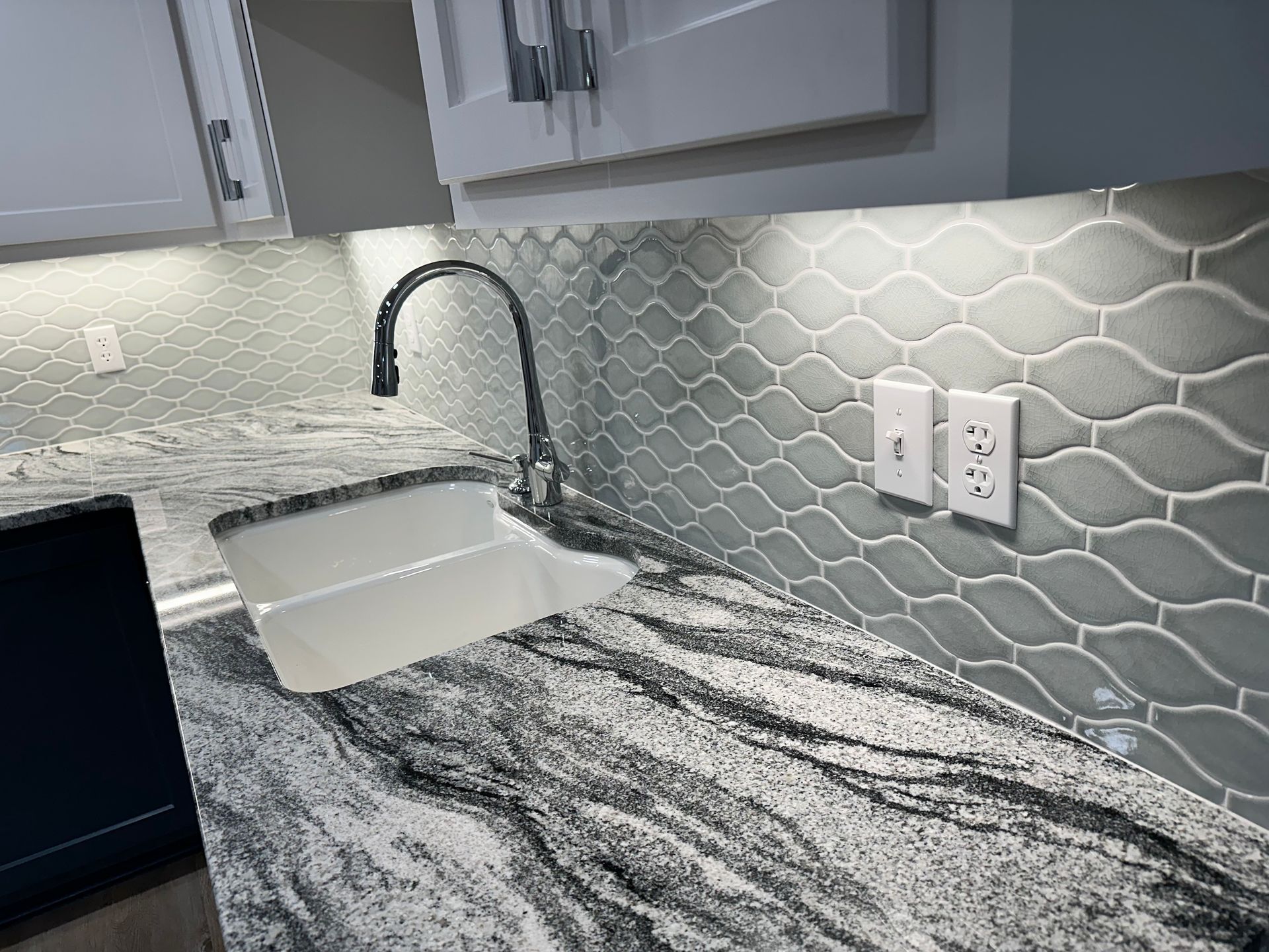 A kitchen with granite counter tops and a sink.
