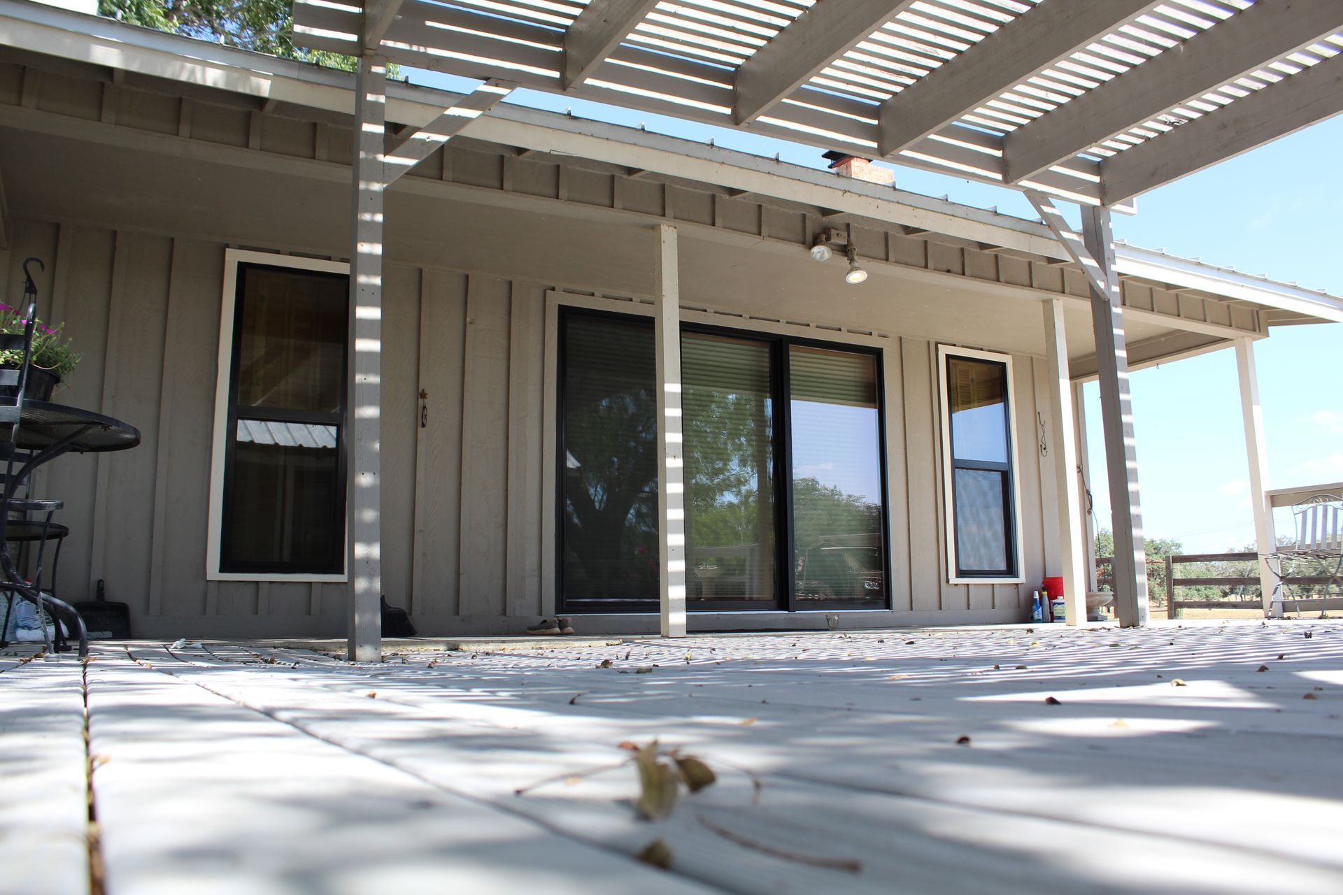 A house with a covered porch and sliding glass doors