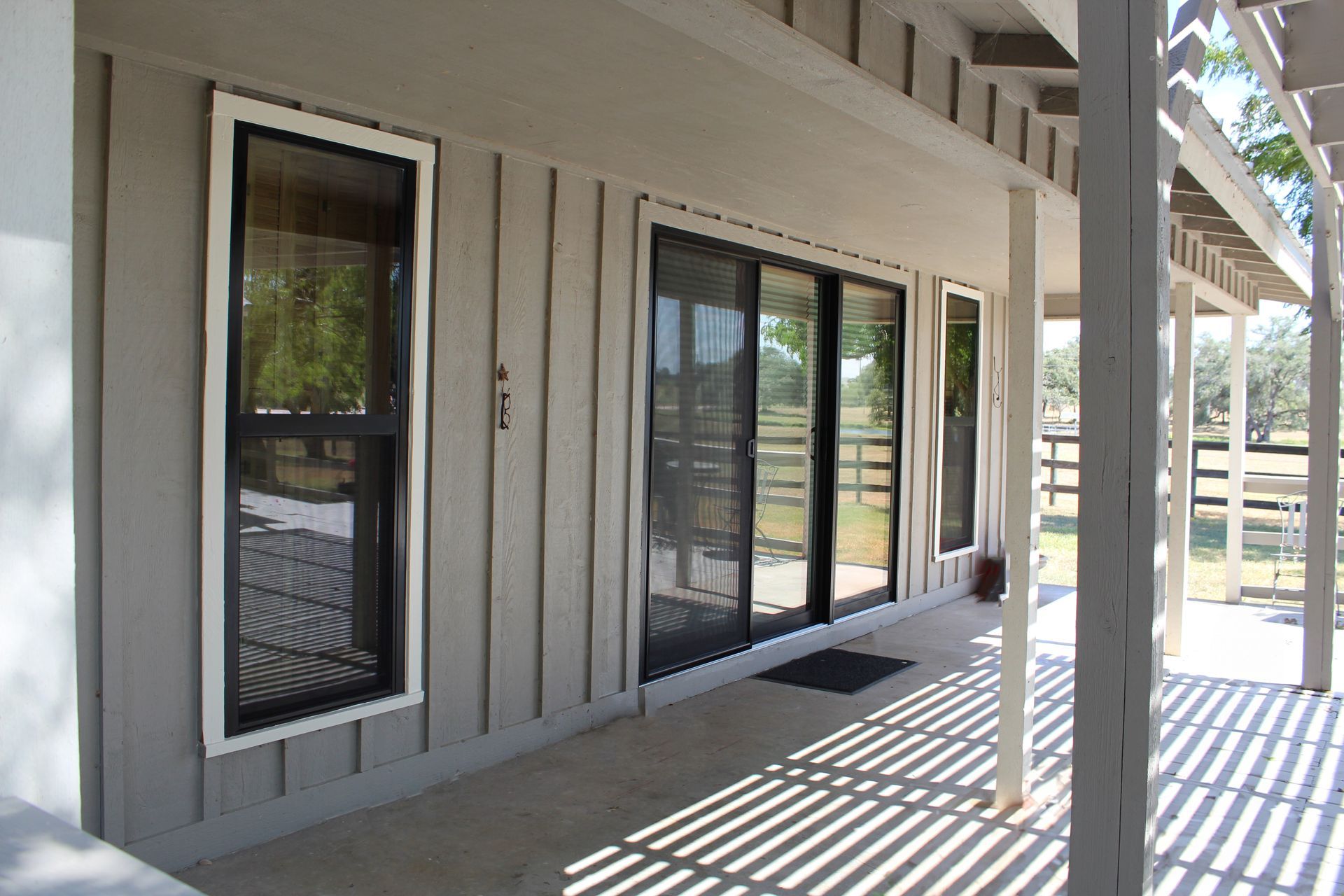 A house with a porch and sliding glass doors