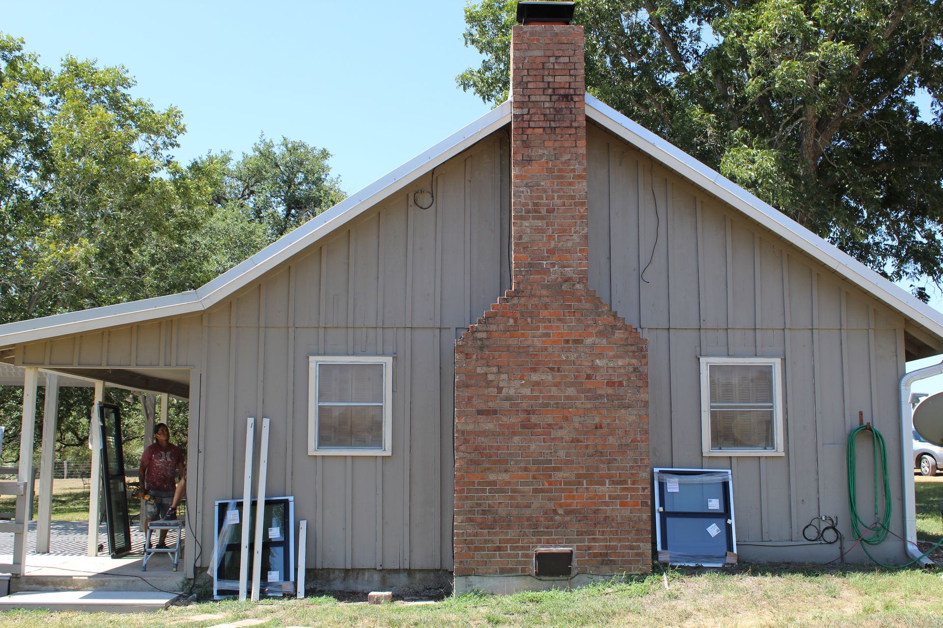 A house with a brick chimney on the side of it